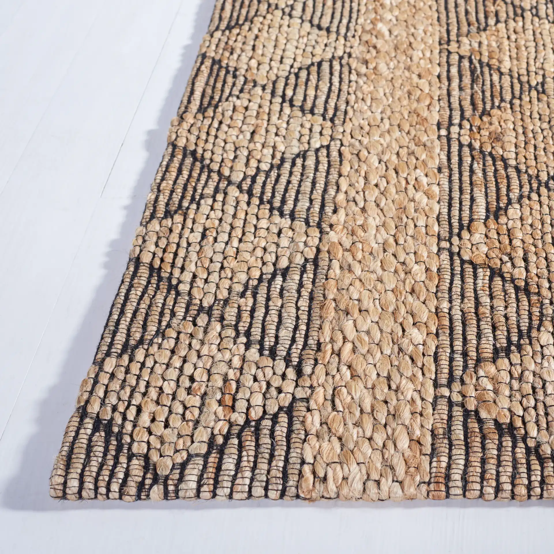 Natural Fiber Banded Diamond Hand-Tufted Rug in Natural / Black in a styled room