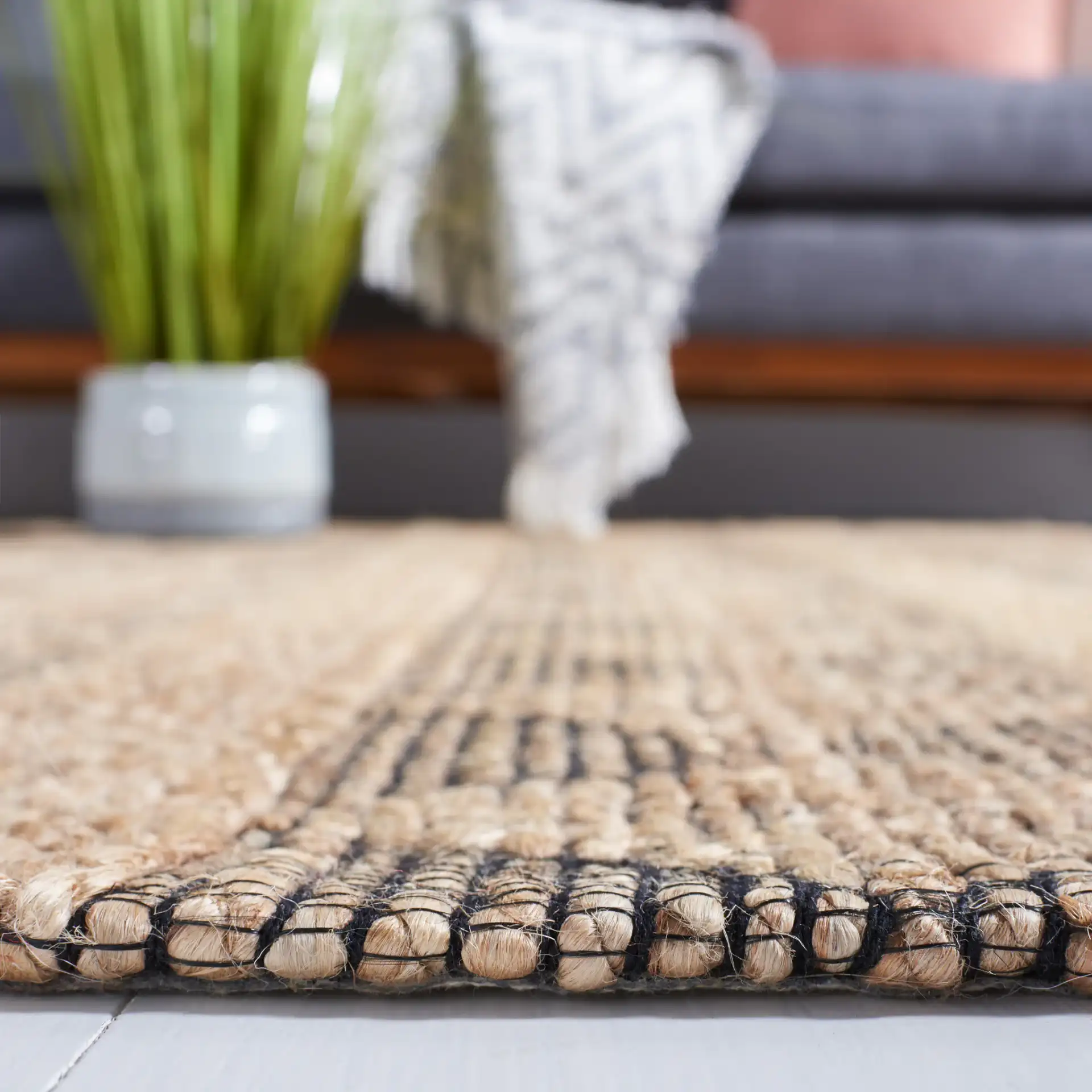 Natural Fiber Banded Diamond Hand-Tufted Rug in Natural / Black in a styled room