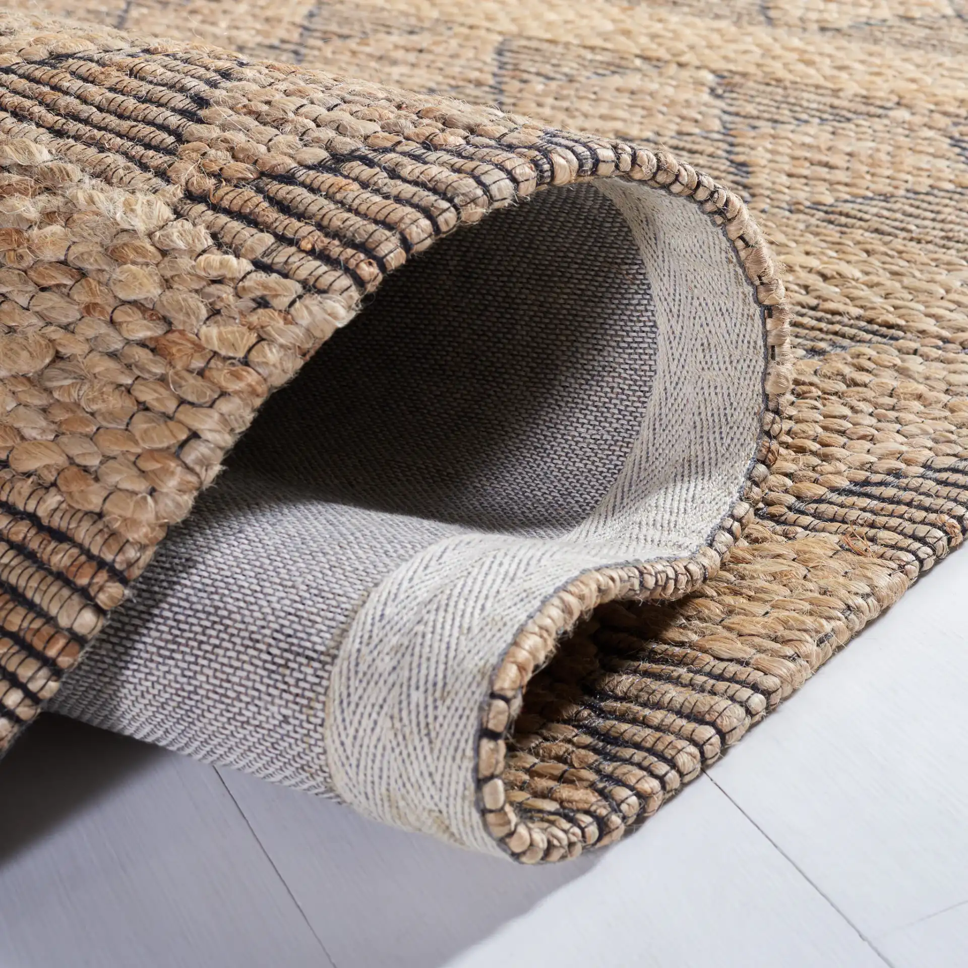 Natural Fiber Banded Diamond Hand-Tufted Rug in Natural / Black in a styled room