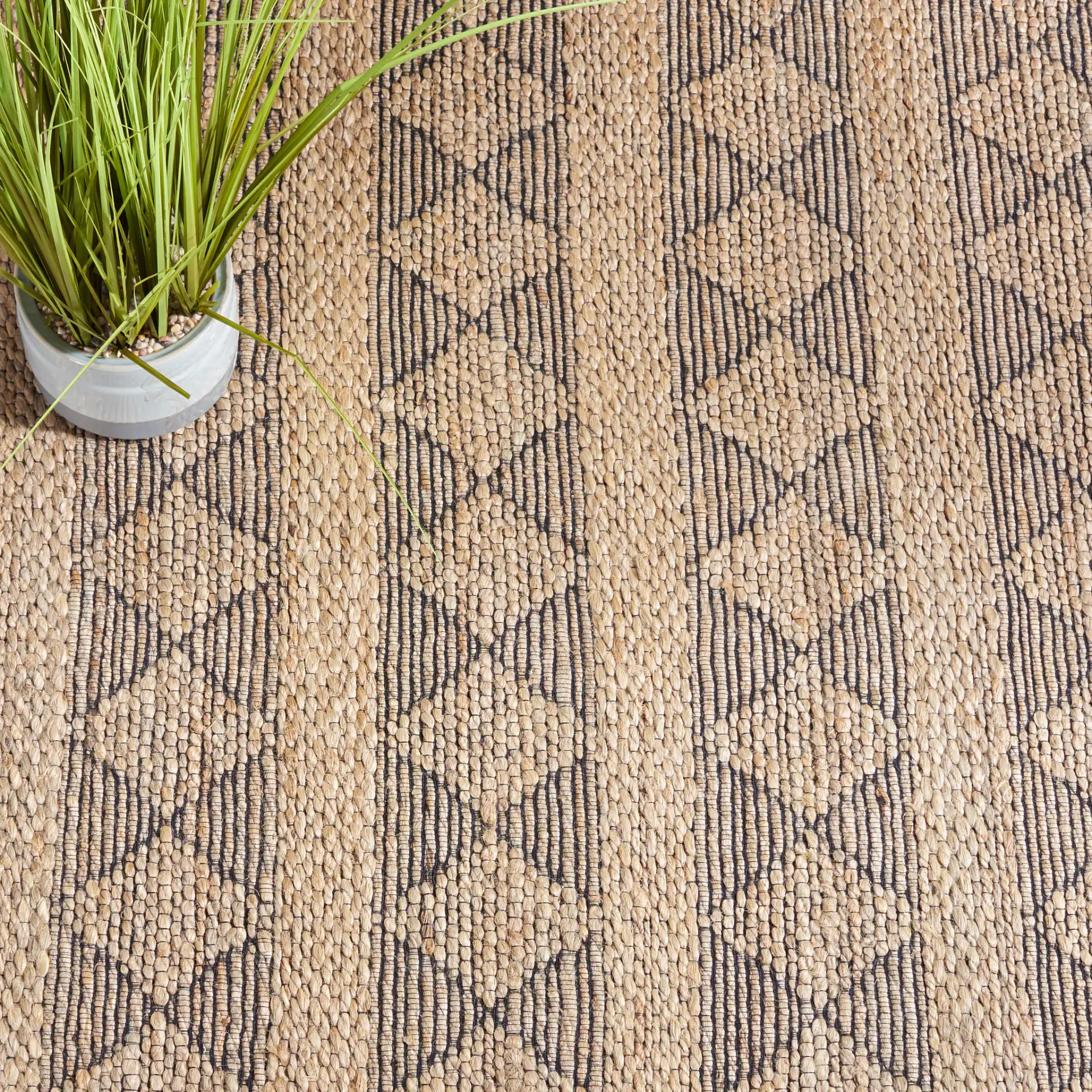 Natural Fiber Banded Diamond Hand-Tufted Rug in Natural / Black in a styled room