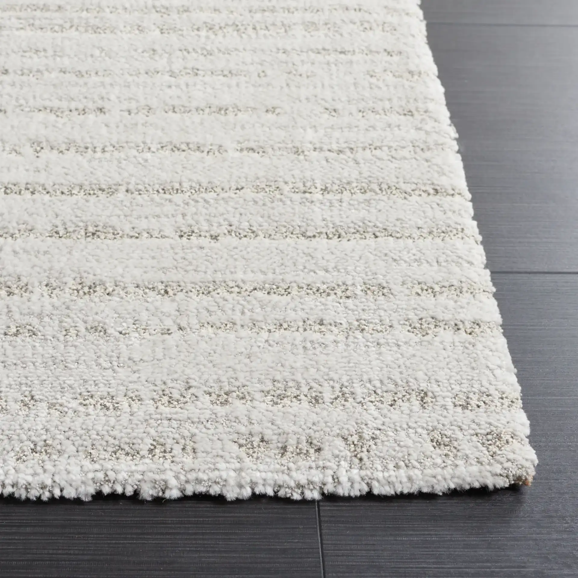 Neptune Ribbed Solid Rug in Light Gray / Gray in a styled room