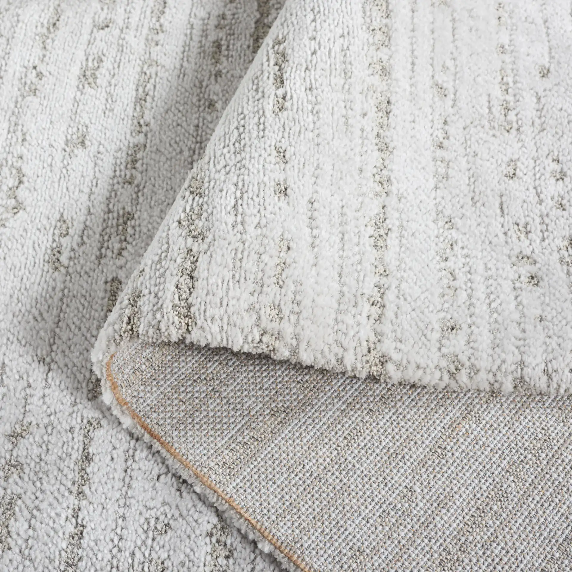 Neptune Ribbed Solid Rug in Light Gray / Gray in a styled room