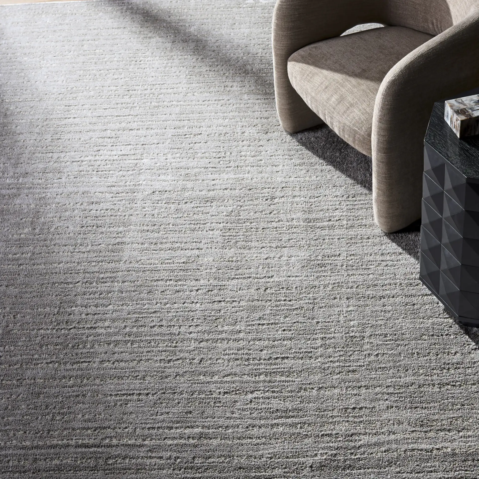 Neptune Ribbed Solid Rug in Light Gray / Gray in a styled room