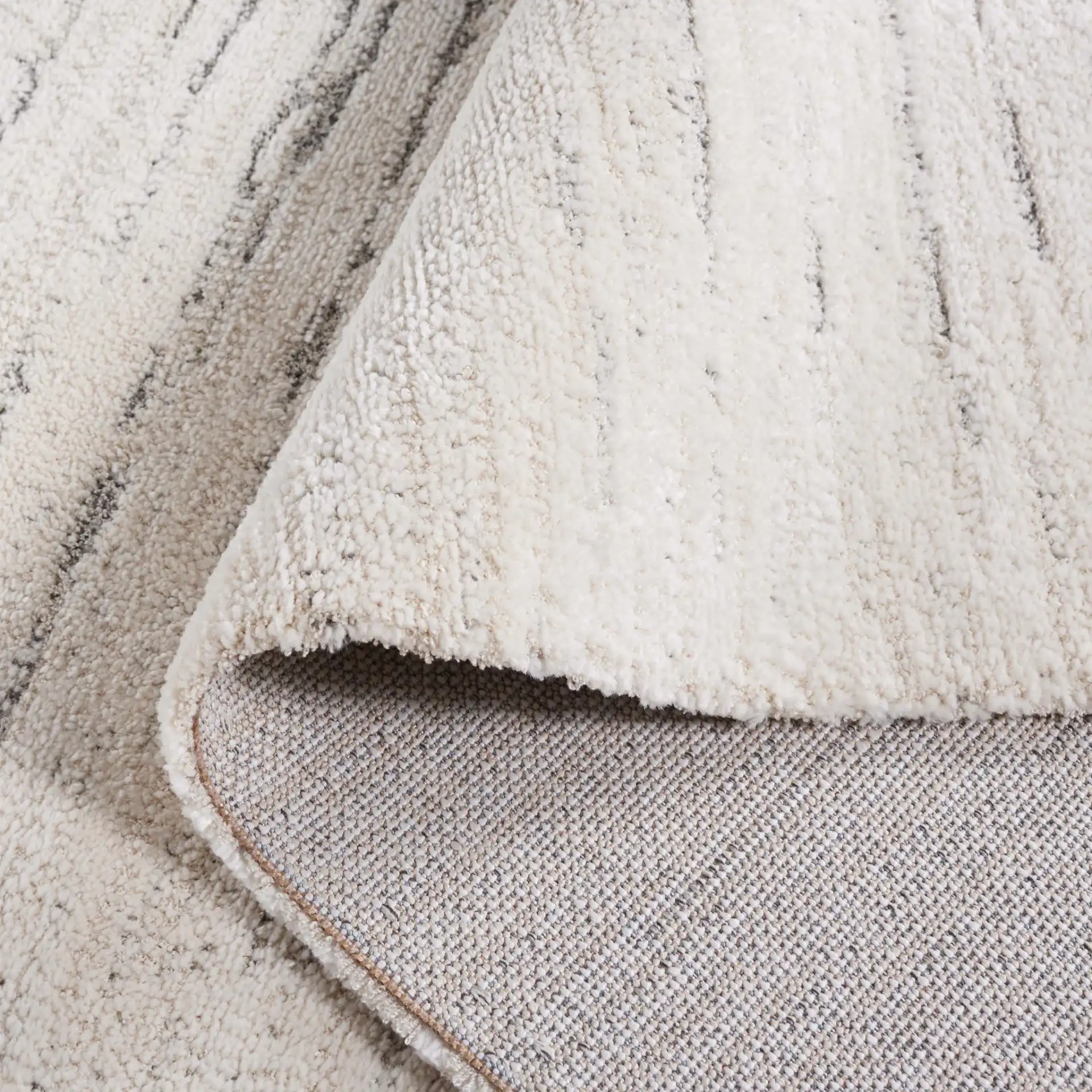Neptune Broken Stripe Rug in Ivory / Gray in a styled room