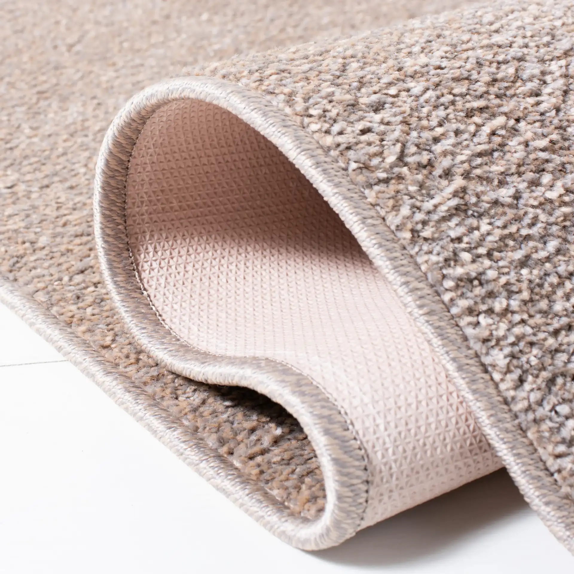 Non-Slip Solid Rug in Taupe in a styled room