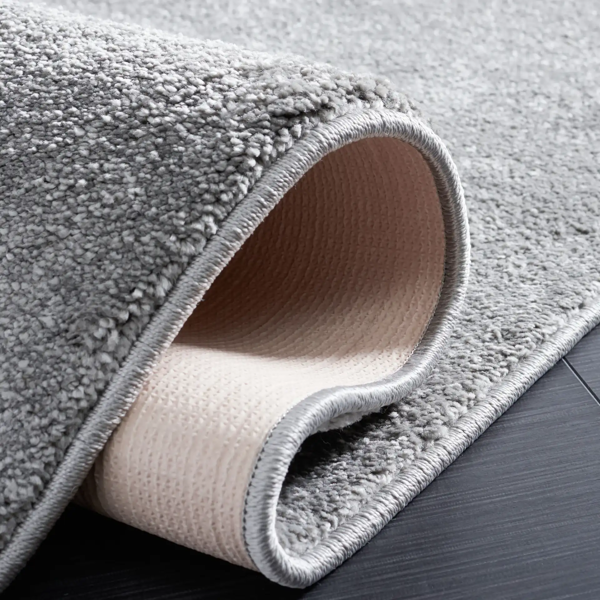 Non-Slip Solid Rug in Gray in a styled room