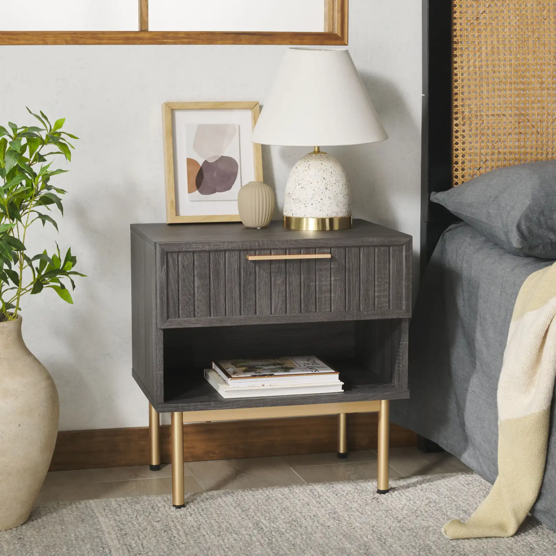 Axelle One-Drawer Nightstand in Distressed Black / Gold in a styled room