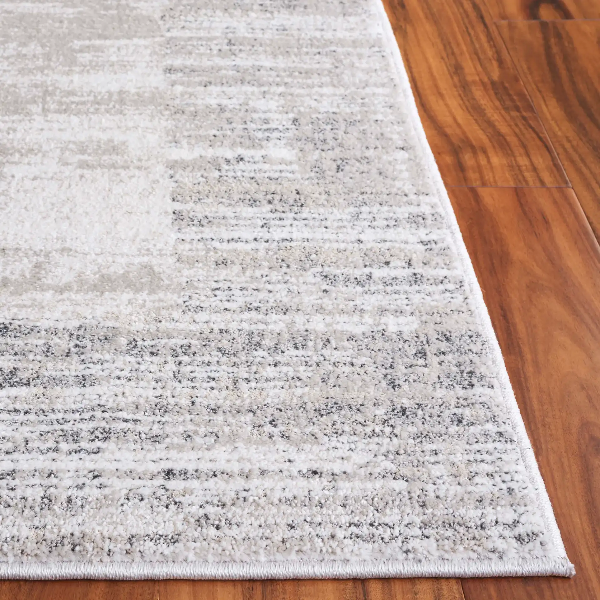 Northport Striated Border Rug in Ivory / Gray in a styled room