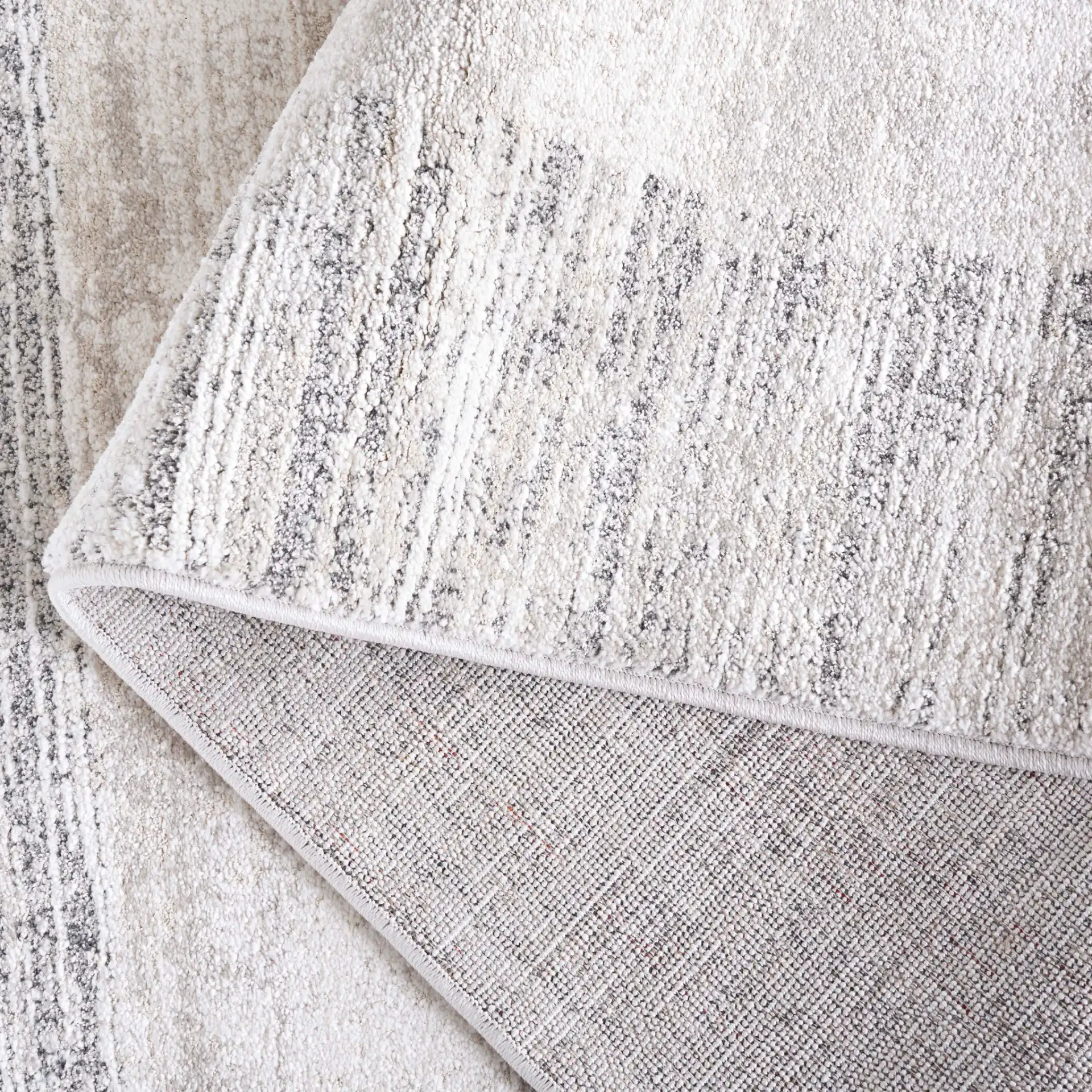 Northport Striated Border Rug in Ivory / Gray in a styled room