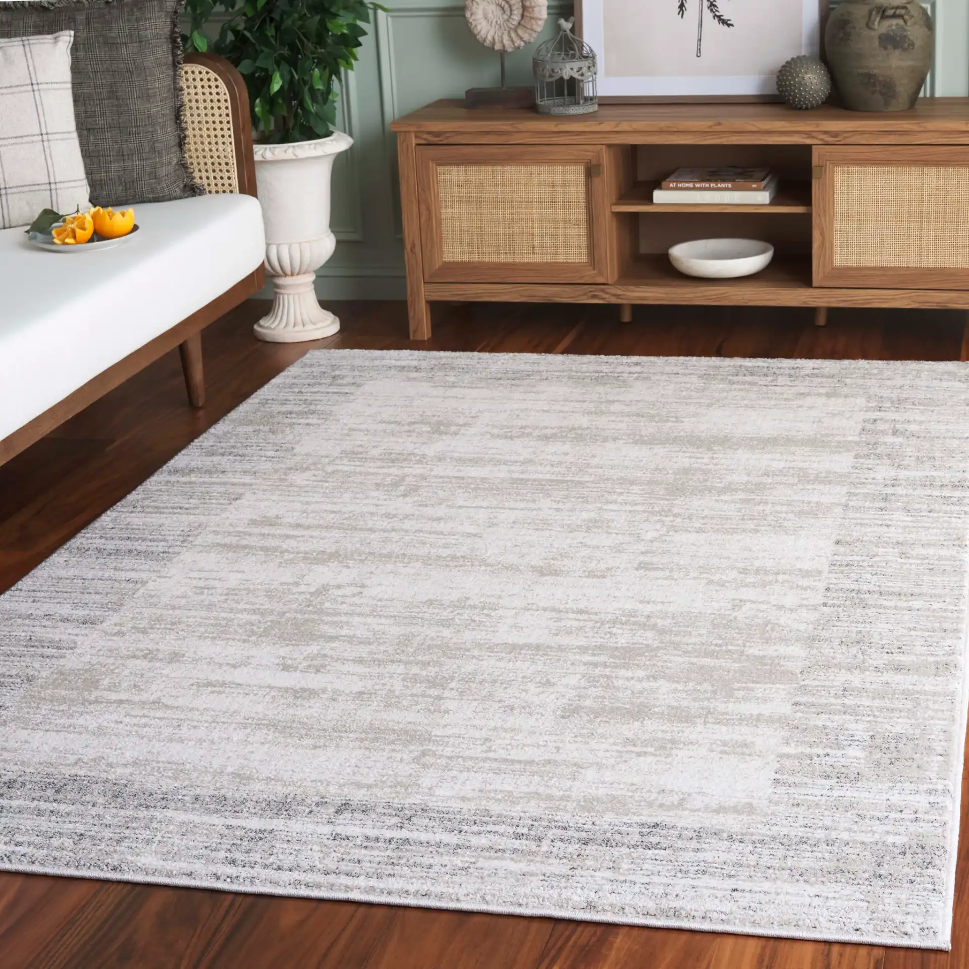 Northport Striated Border Rug in Ivory / Gray in a styled room