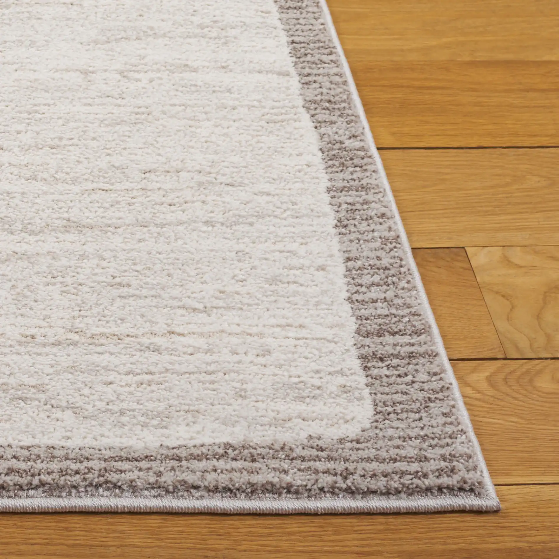 Northport Banded Stripe Rug in Ivory / Beige in a styled room