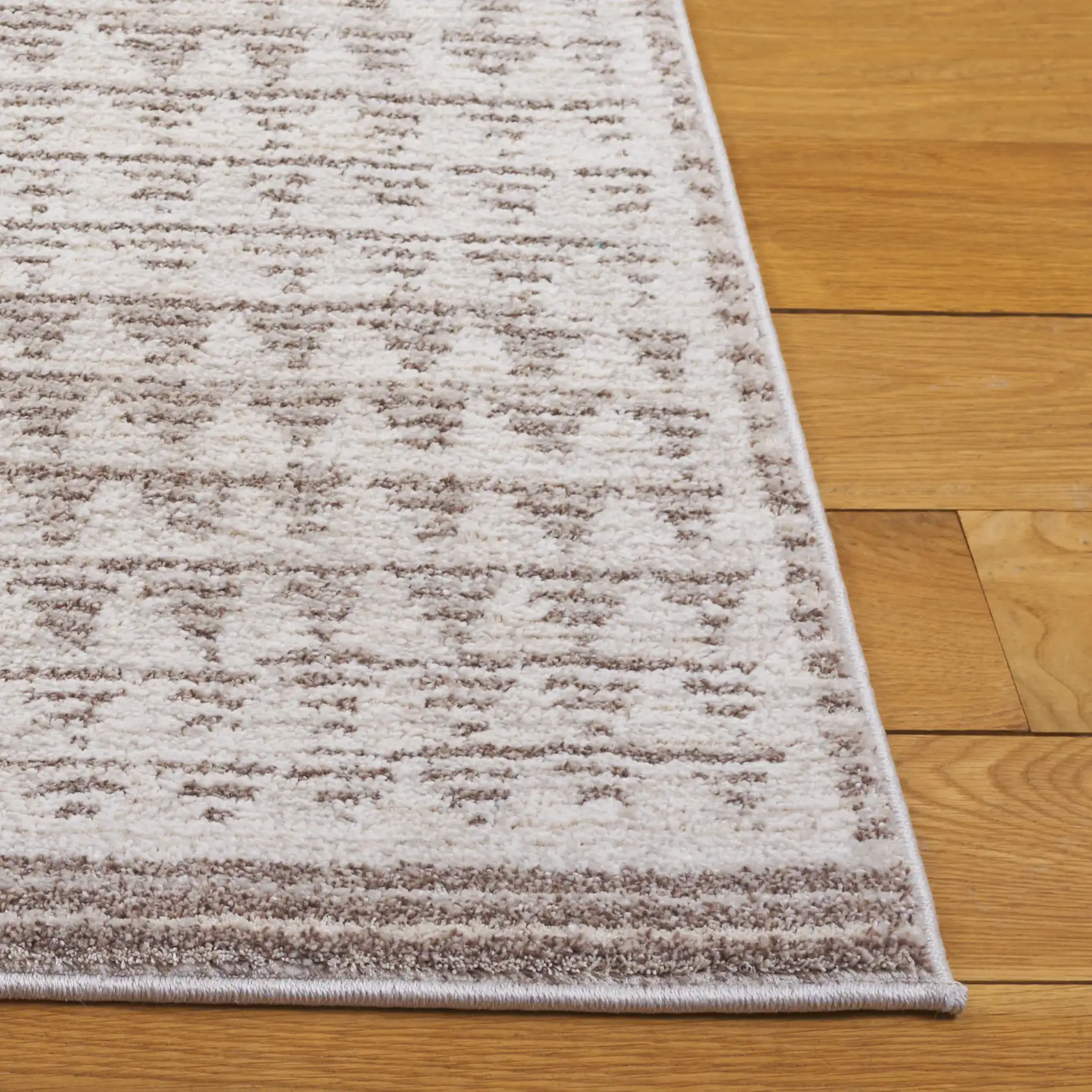 Northport Triangle Stripe Rug in Ivory / Beige in a styled room