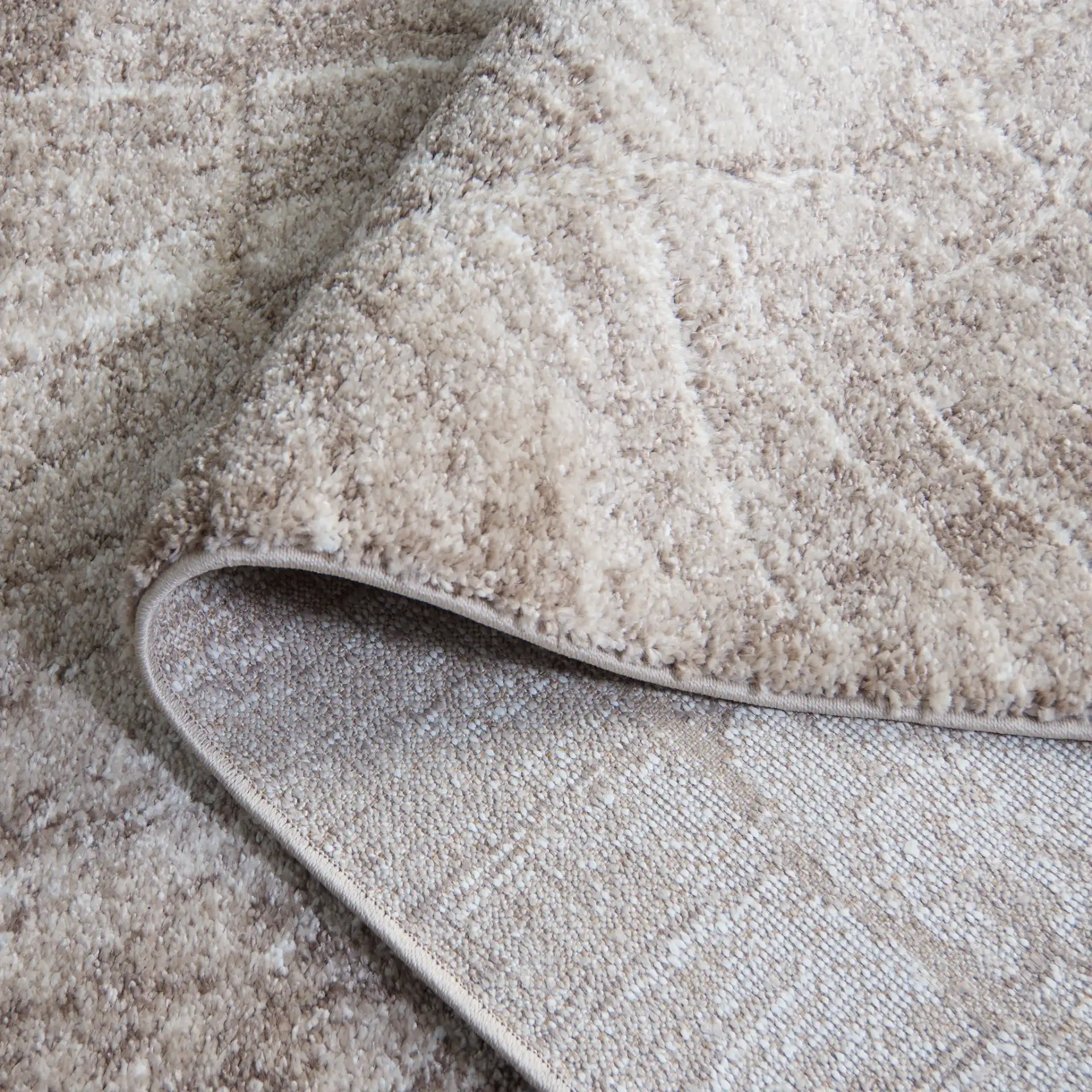 Northport Radial Ring Rug in Taupe / Ivory in a styled room