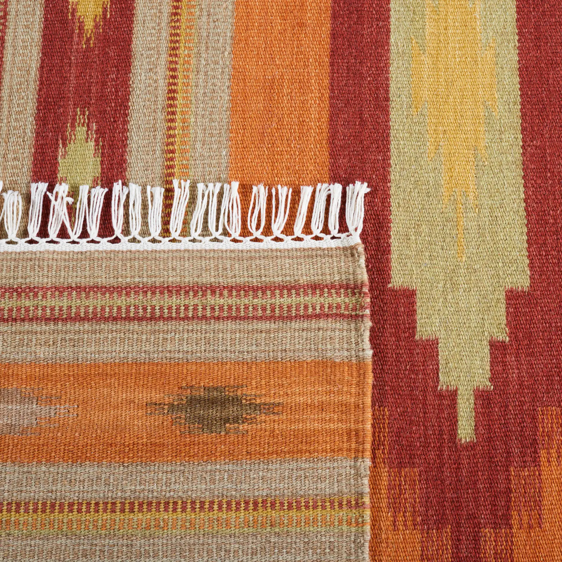 Kilim Southwestern Striped Hand-Woven Wool Rug in Brown / Multicolor in a styled room