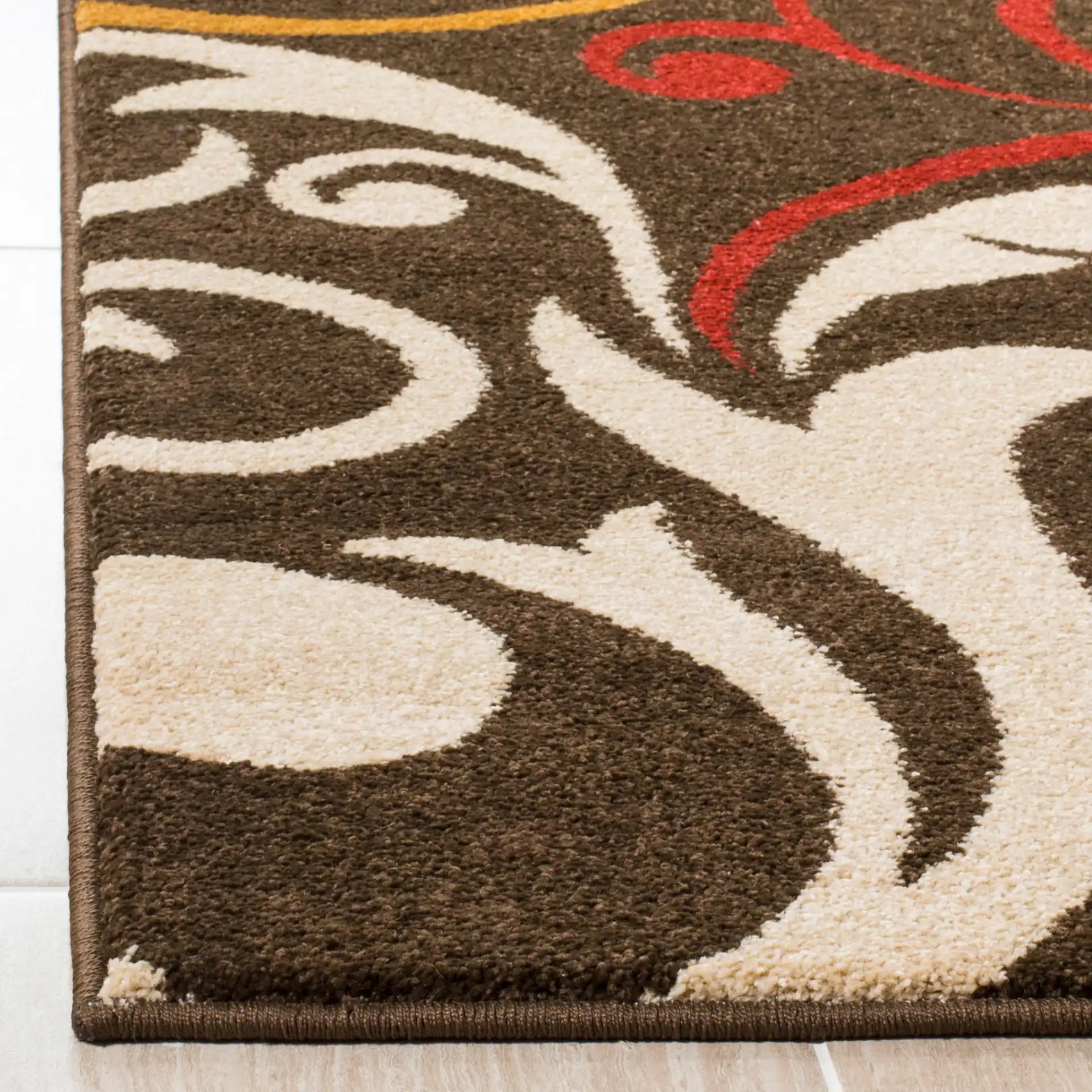 Newbury Swirling Scroll Rug in Brown / Gold in a styled room