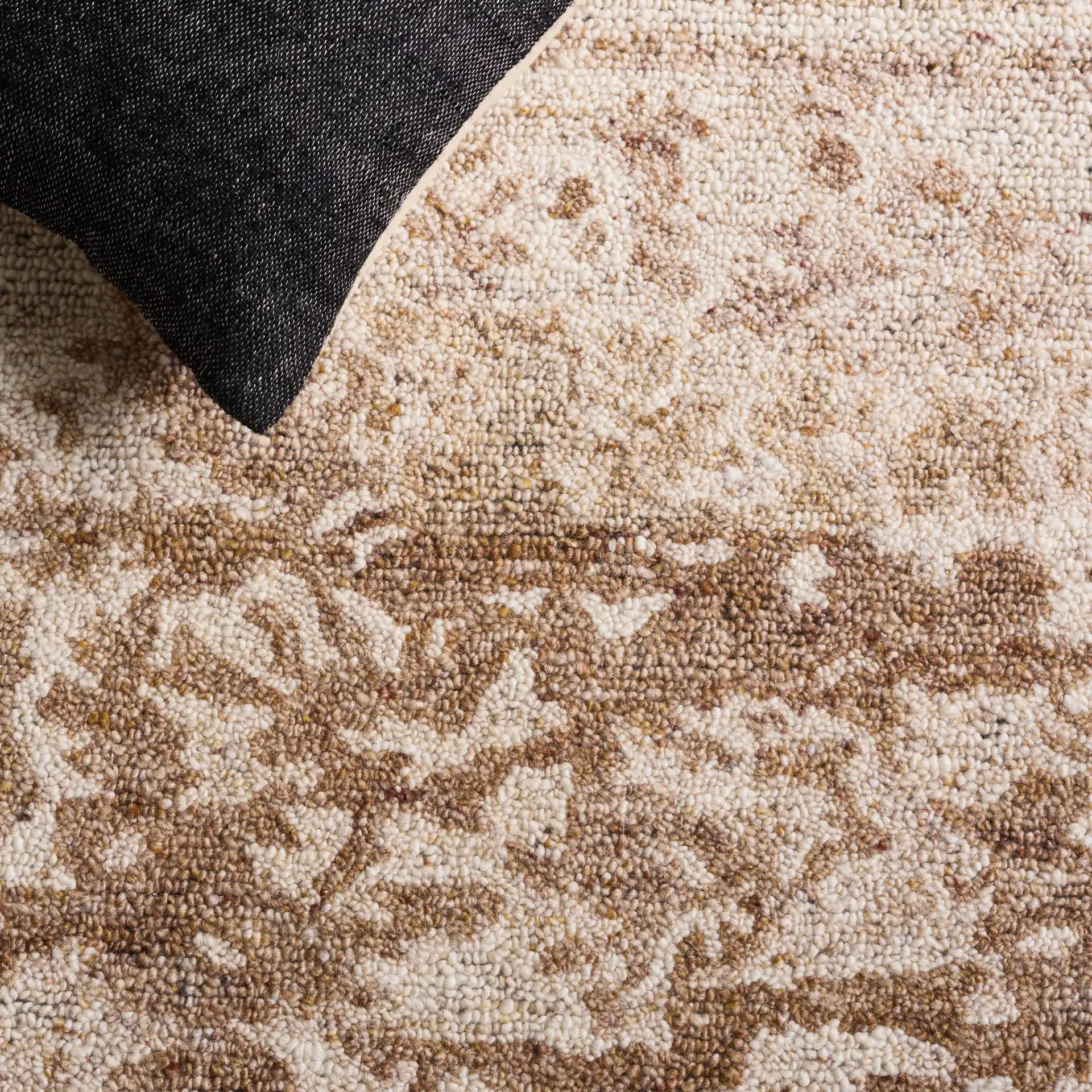 Oakwood Abstract Mottled Hand-Tufted Wool Rug in Natural / Brown in a styled room