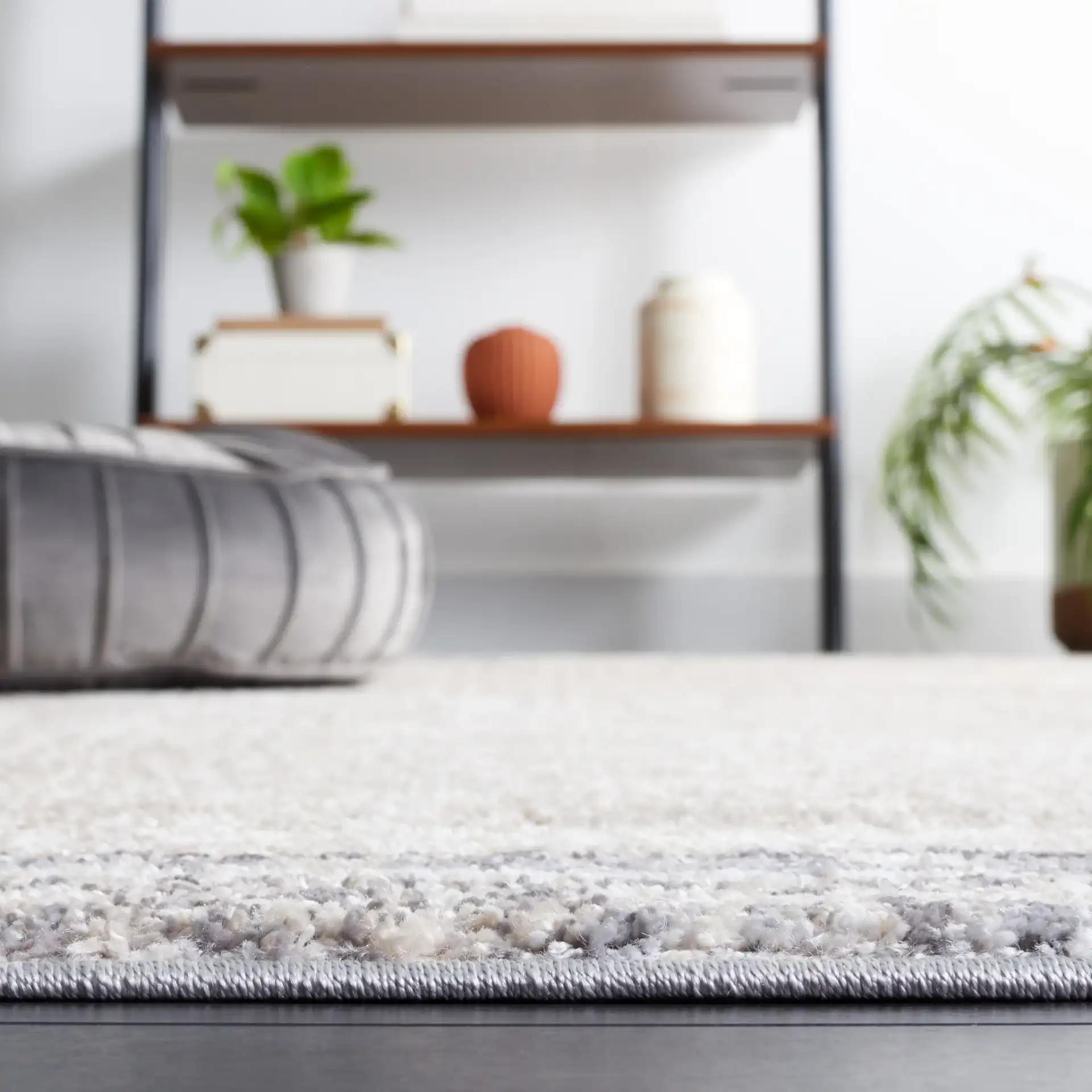 Opal Abstract Border Rug in Ivory / Gray in a styled room
