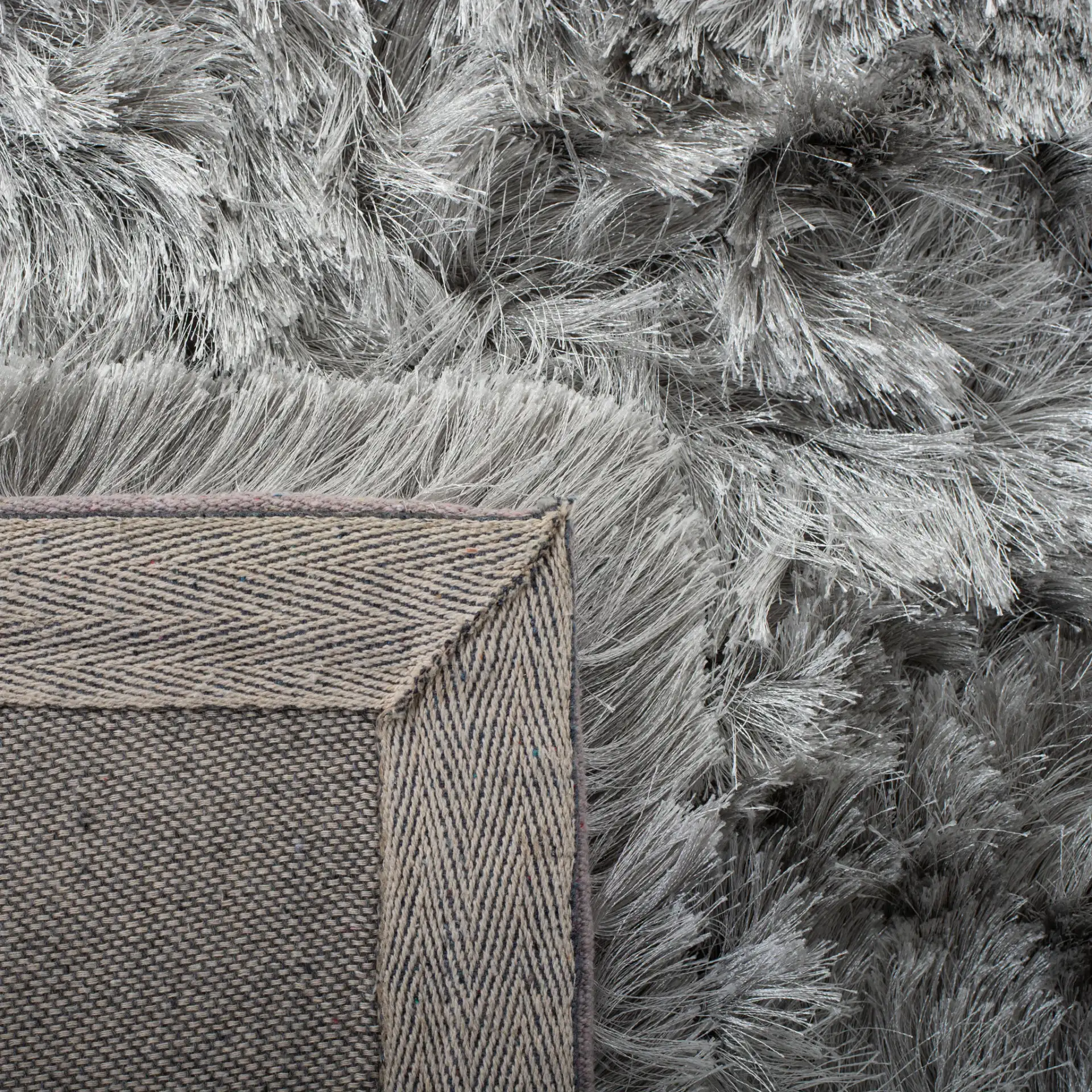Ocean Textured Solid Hand-Tufted Shag Rug in Silver in a styled room