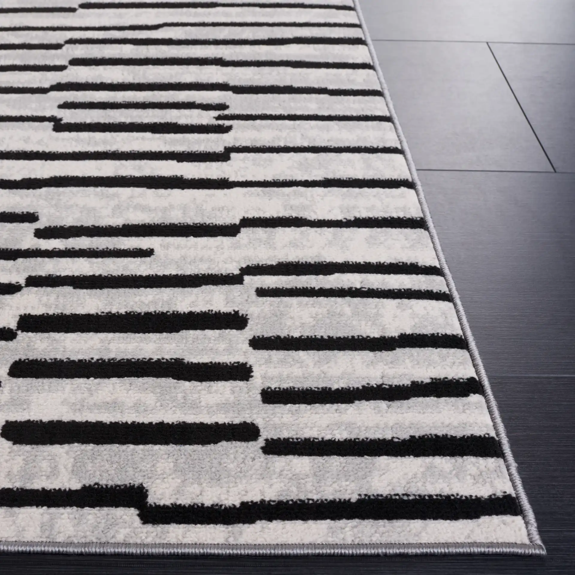 Odyssey Broken Stripe Rug in Gray / Black in a styled room