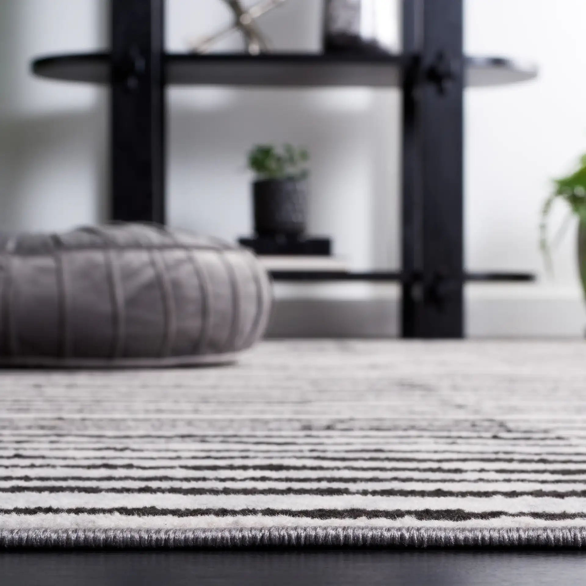 Odyssey Broken Stripe Rug in Gray / Black in a styled room