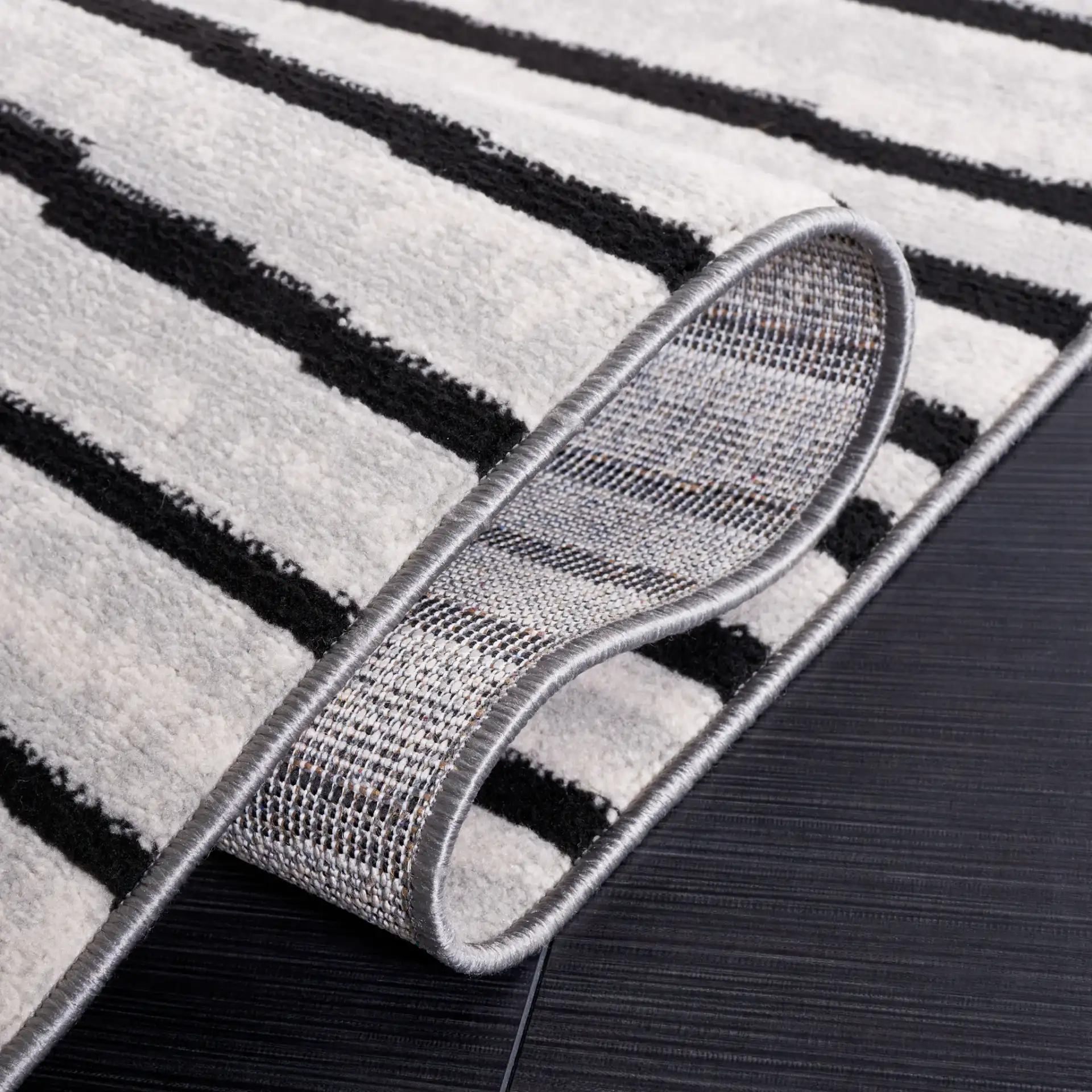 Odyssey Broken Stripe Rug in Gray / Black in a styled room