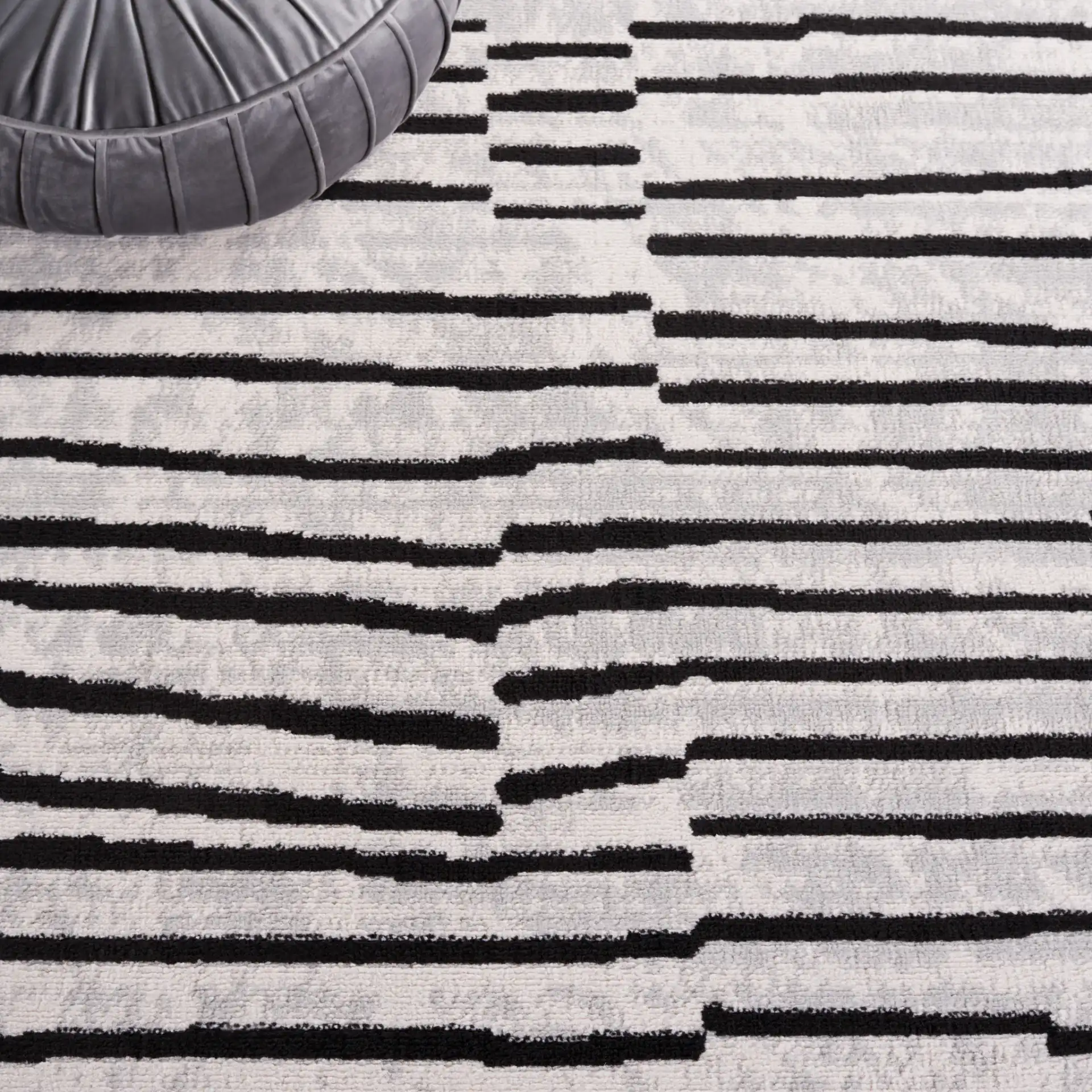 Odyssey Broken Stripe Rug in Gray / Black in a styled room