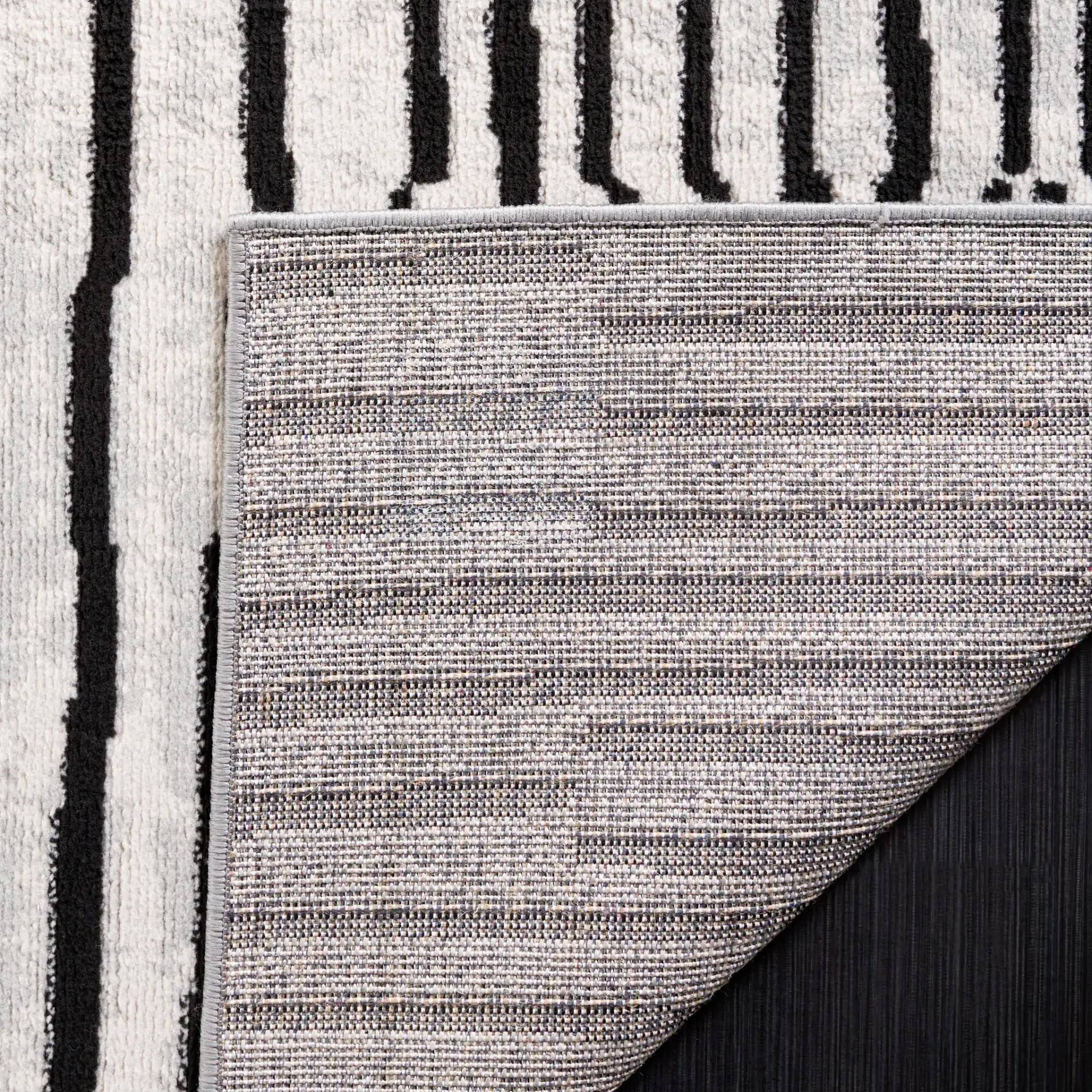 Odyssey Broken Stripe Rug in Gray / Black in a styled room