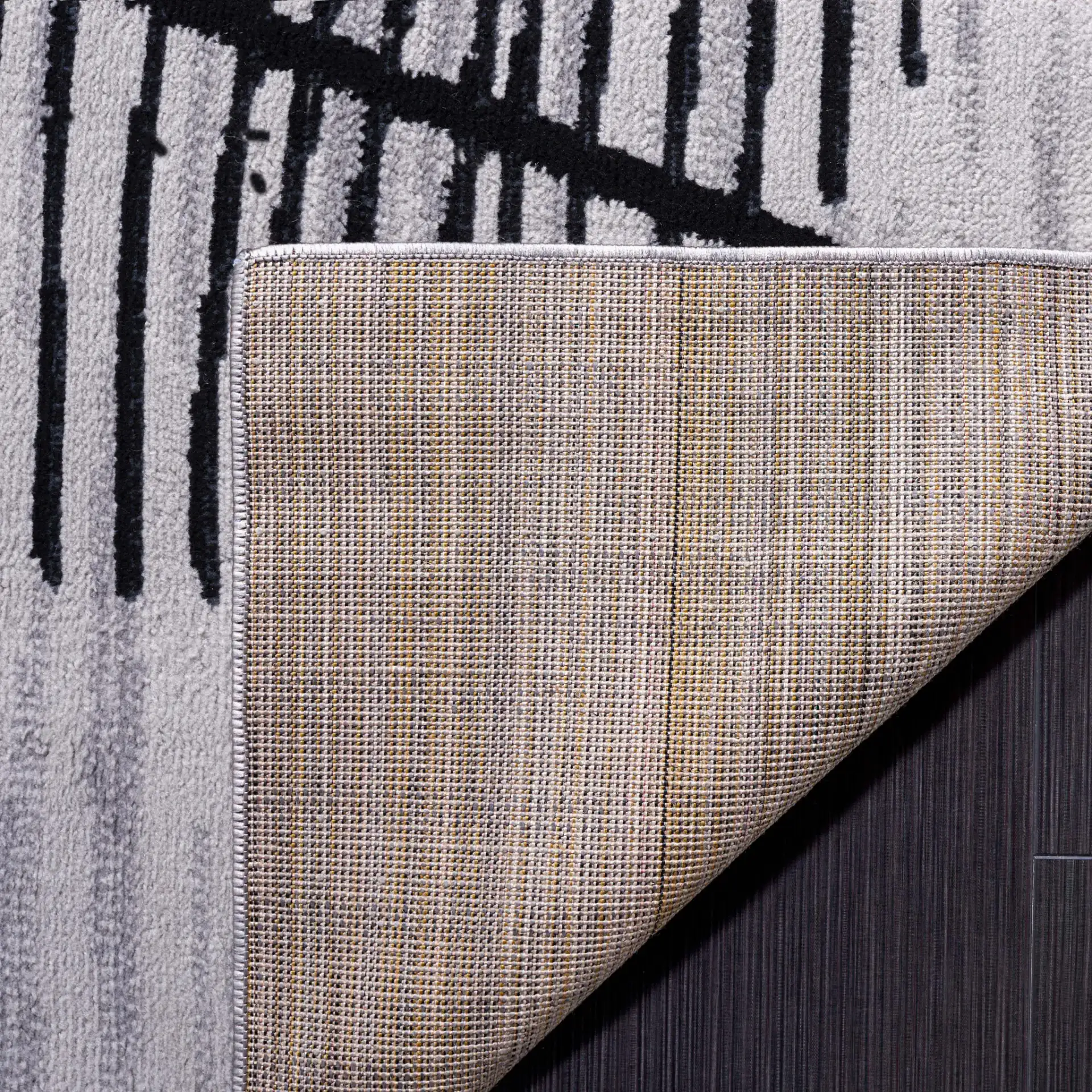 Odyssey Abstract Grid Rug in Gray / Gold in a styled room