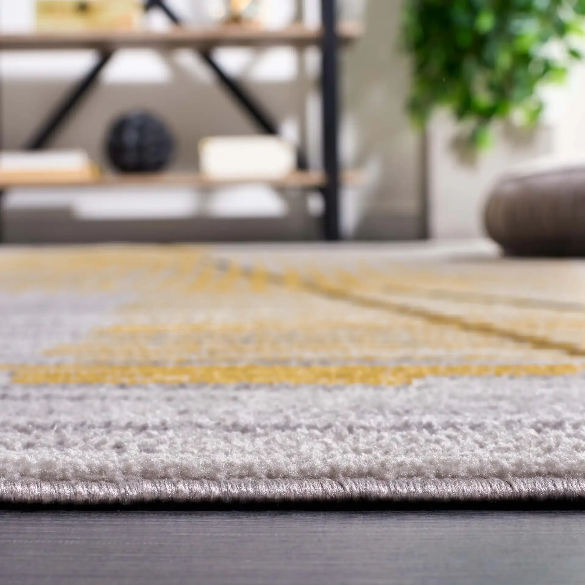 Odyssey Abstract Grid Rug in Gray / Gold in a styled room