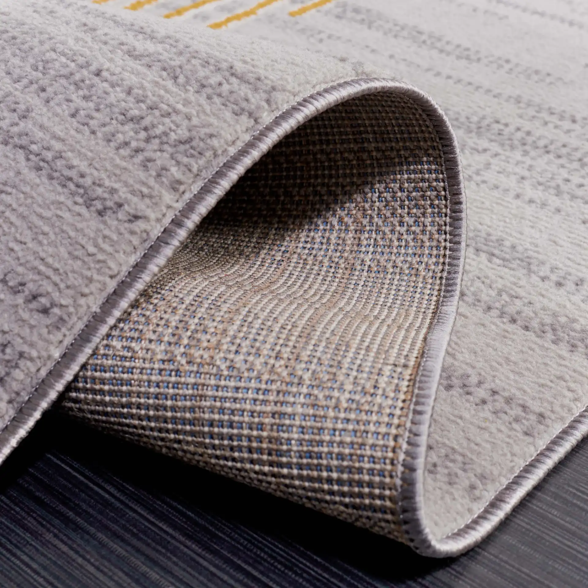 Odyssey Abstract Grid Rug in Gray / Gold in a styled room