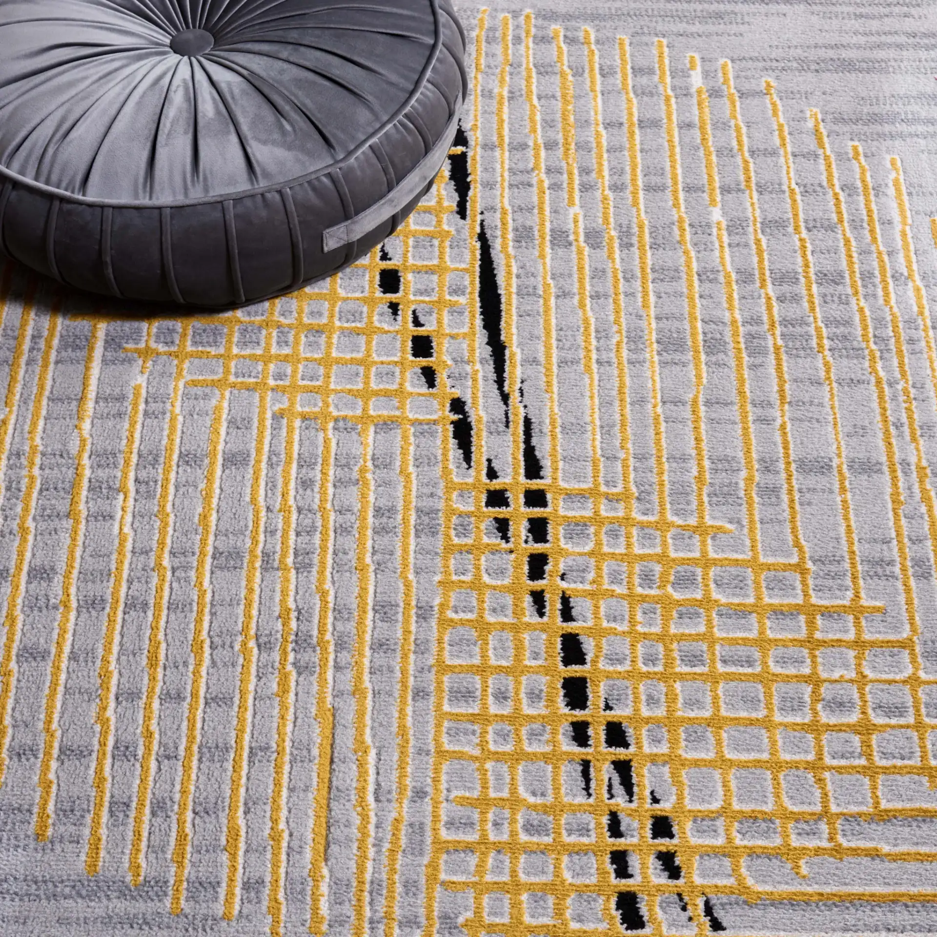 Odyssey Abstract Grid Rug in Gray / Gold in a styled room