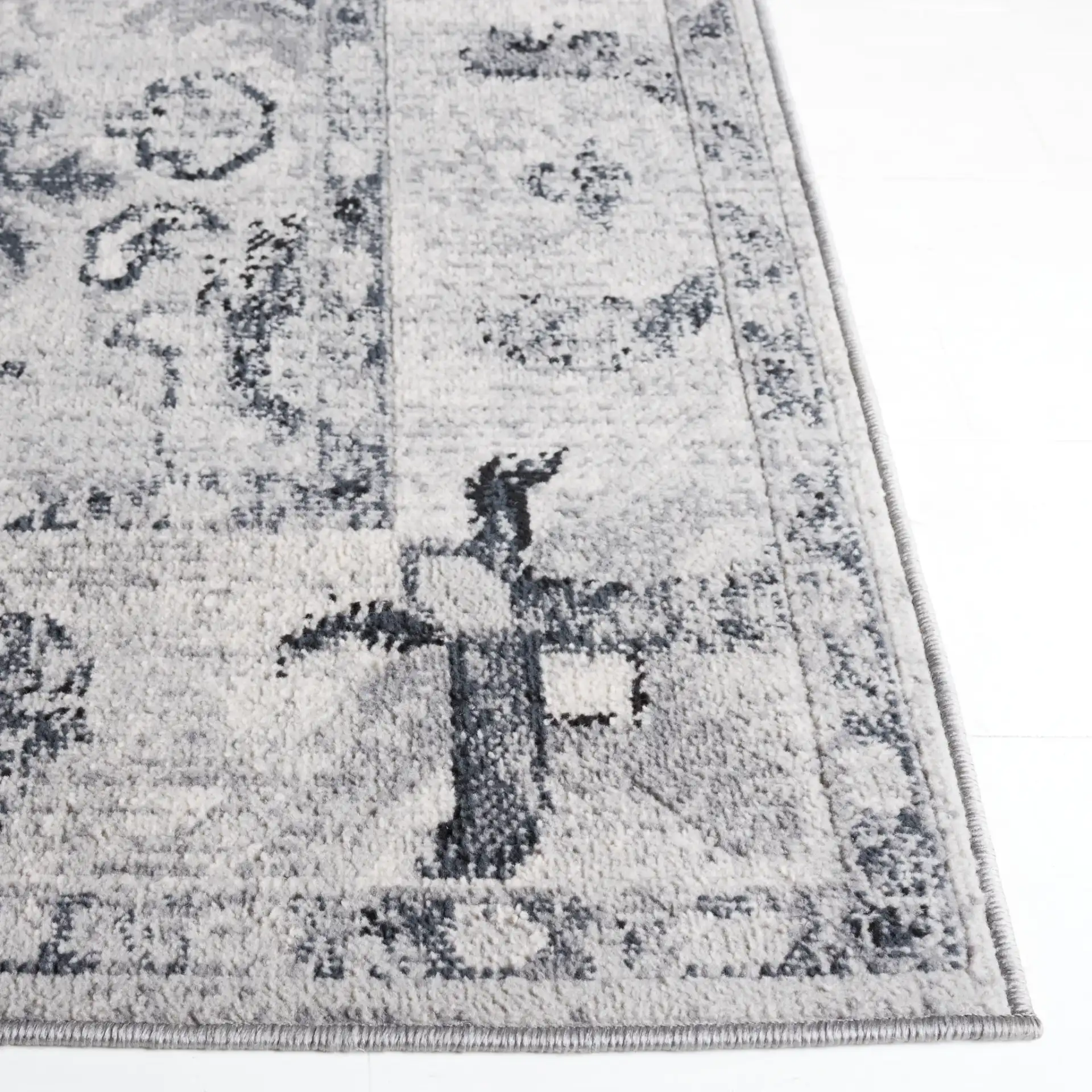 Odyssey Bordered Medallion Rug in Gray / Black in a styled room