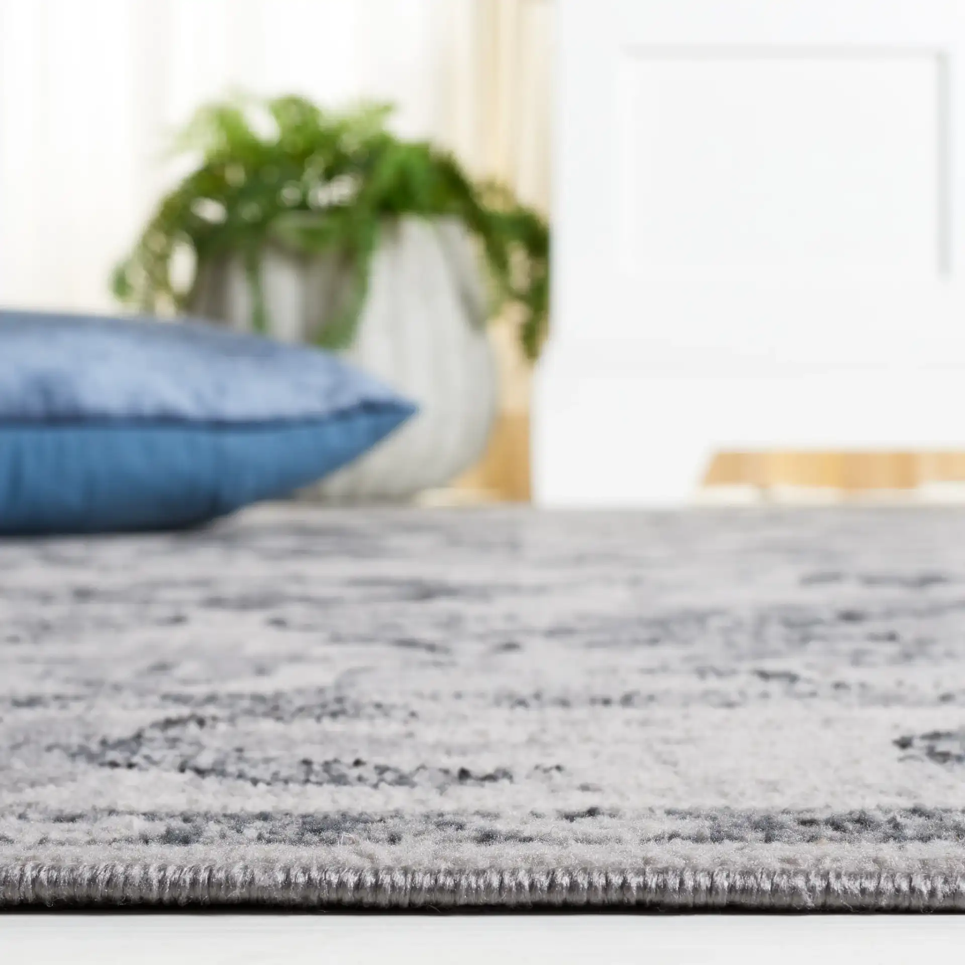 Odyssey Bordered Medallion Rug in Gray / Black in a styled room