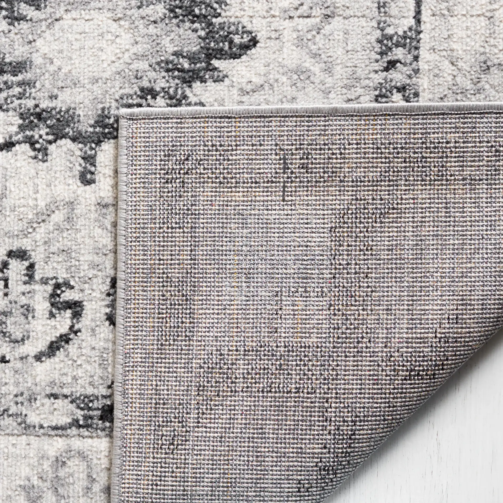 Odyssey Bordered Medallion Rug in Gray / Black in a styled room