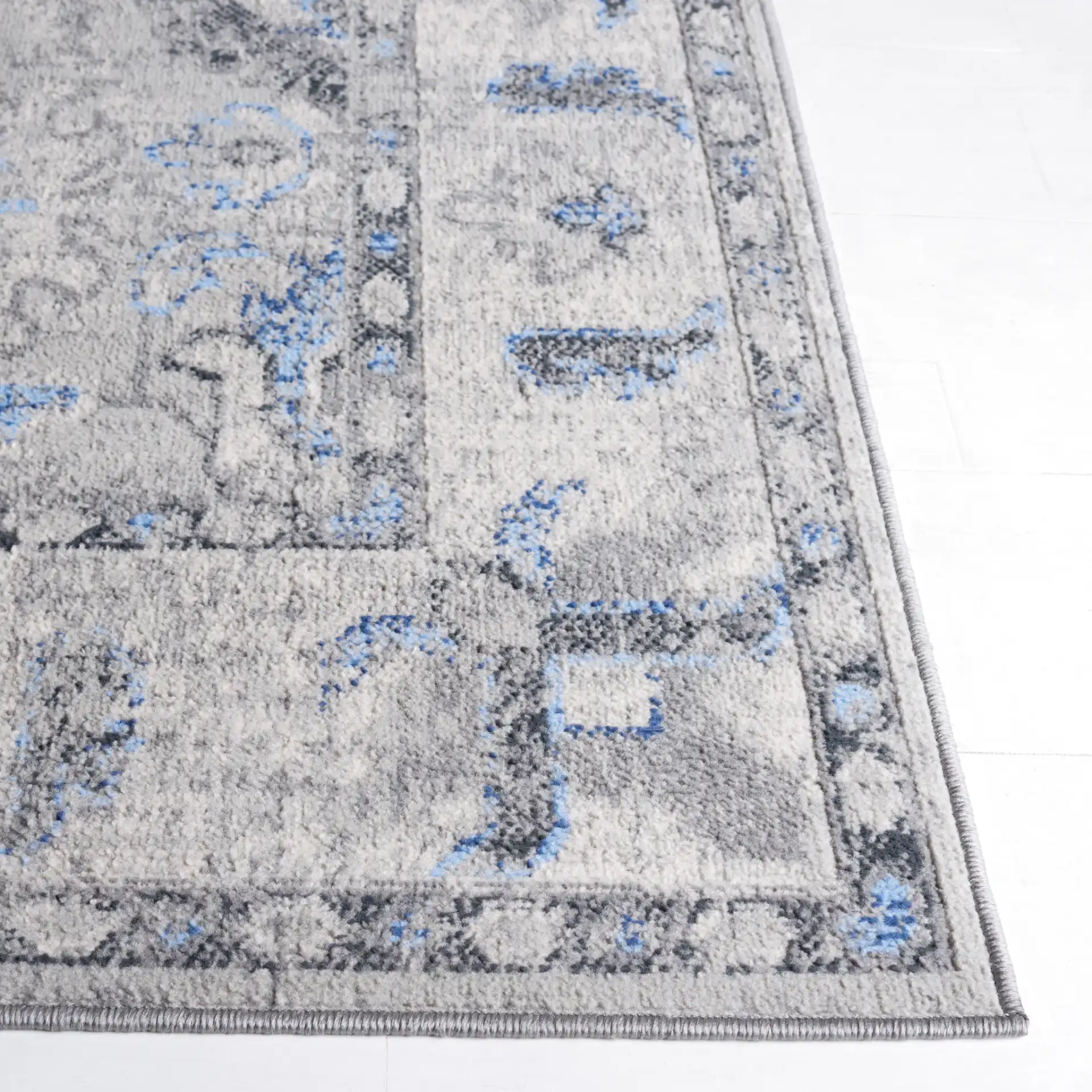 Odyssey Bordered Medallion Rug in Gray / Blue in a styled room