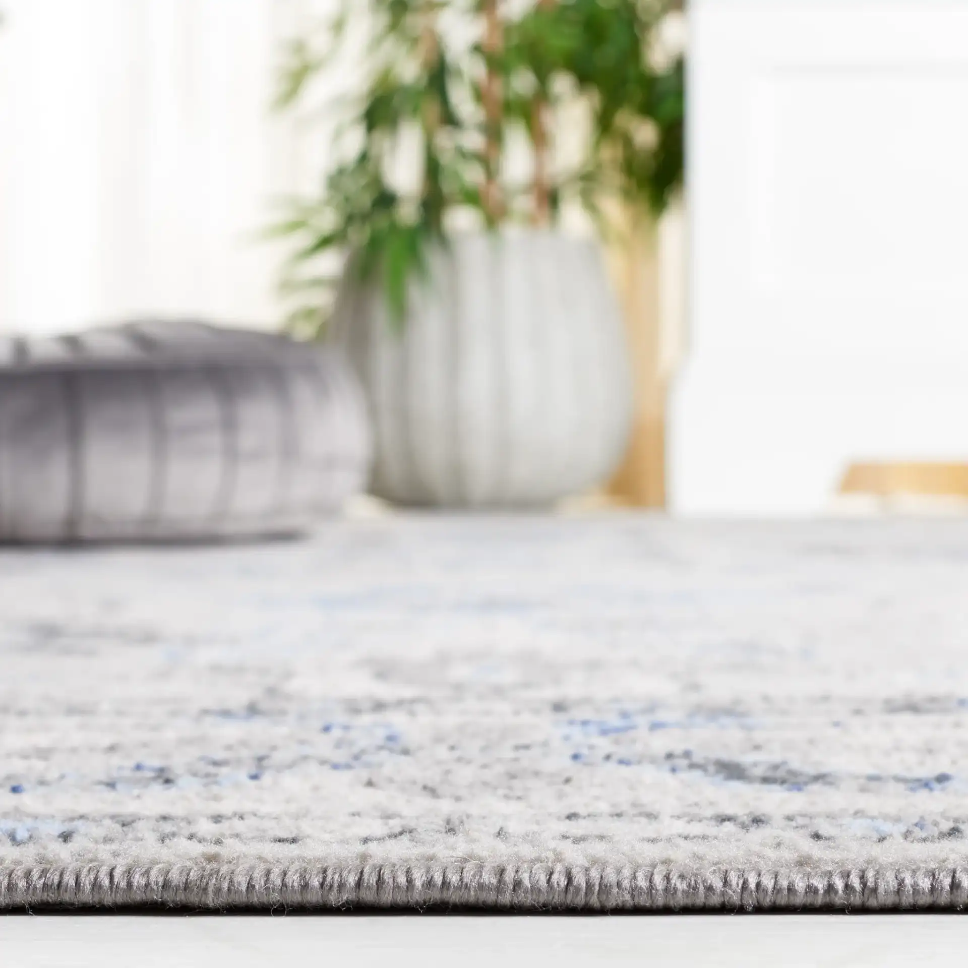 Odyssey Bordered Medallion Rug in Gray / Blue in a styled room