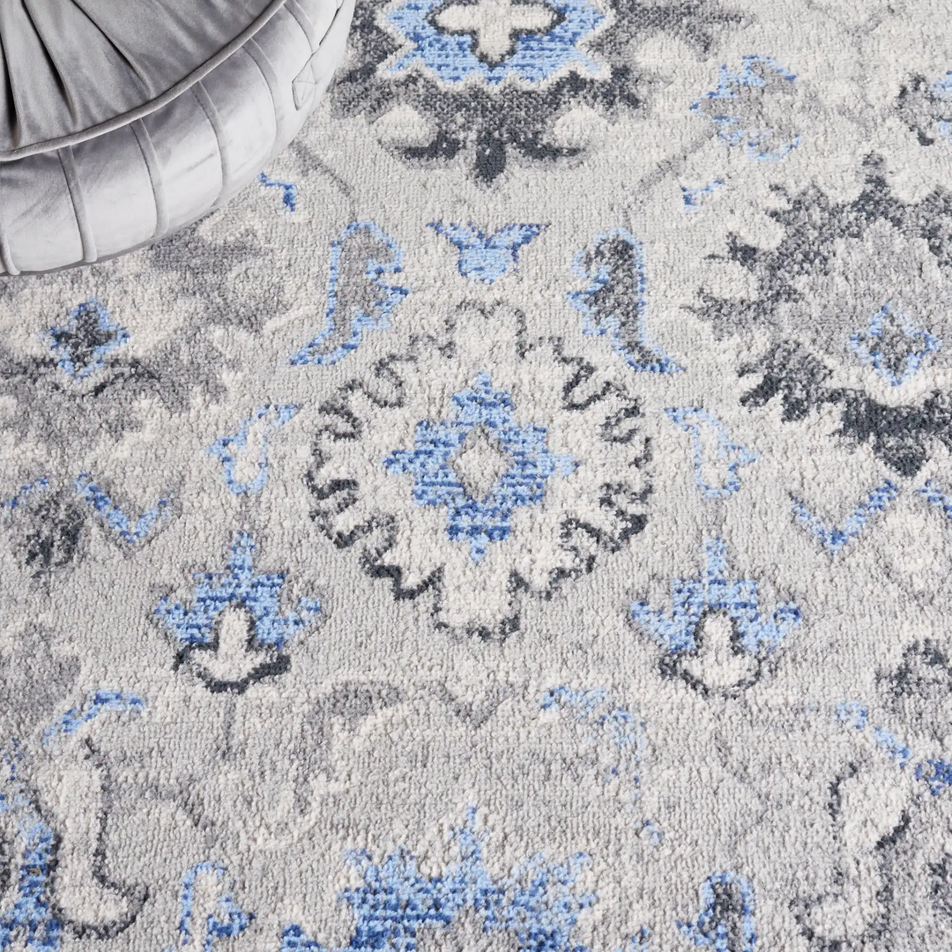 Odyssey Bordered Medallion Rug in Gray / Blue in a styled room