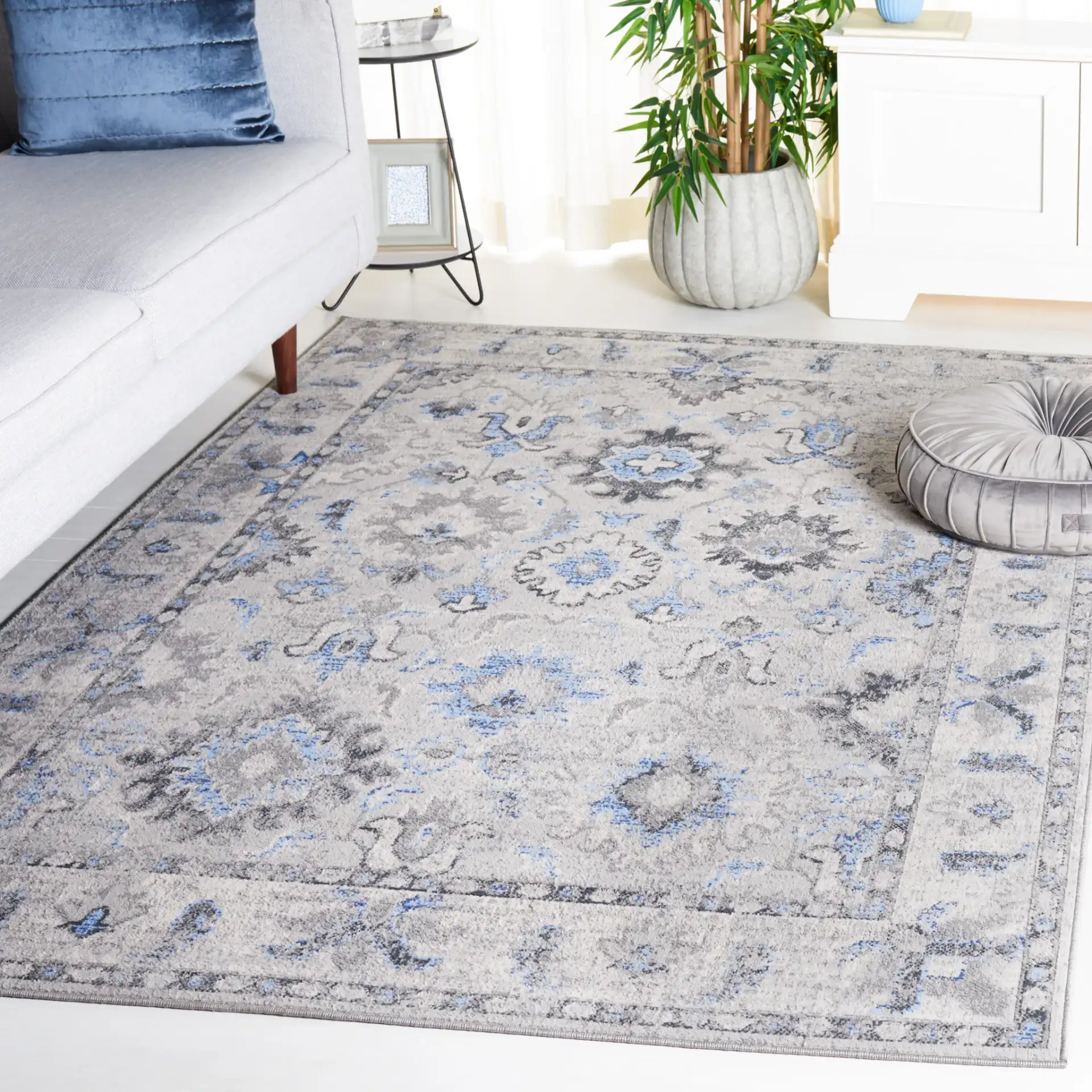Odyssey Bordered Medallion Rug in Gray / Blue in a styled room