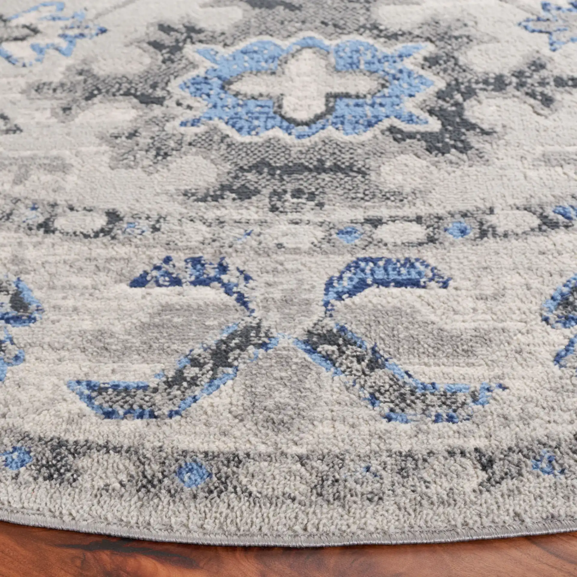Odyssey Bordered Medallion Rug in Gray / Blue in a styled room