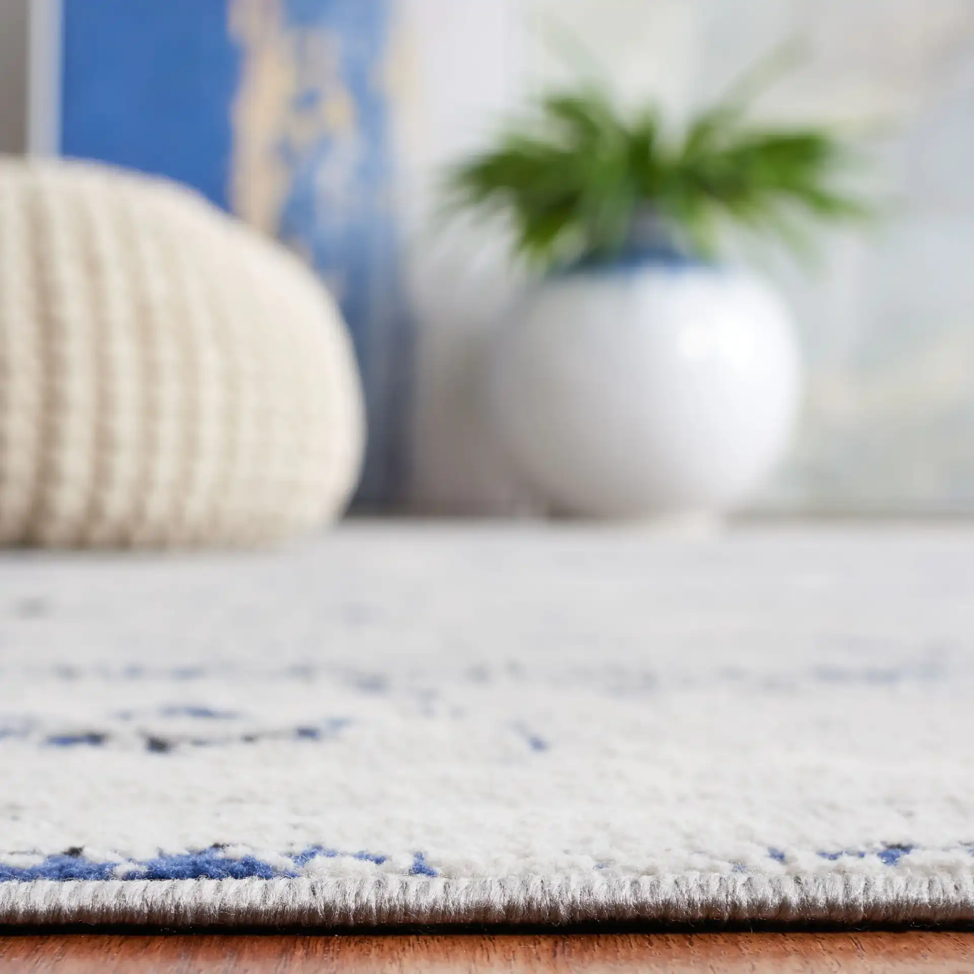 Odyssey Distressed Floral Border Rug in Gray / Navy in a styled room