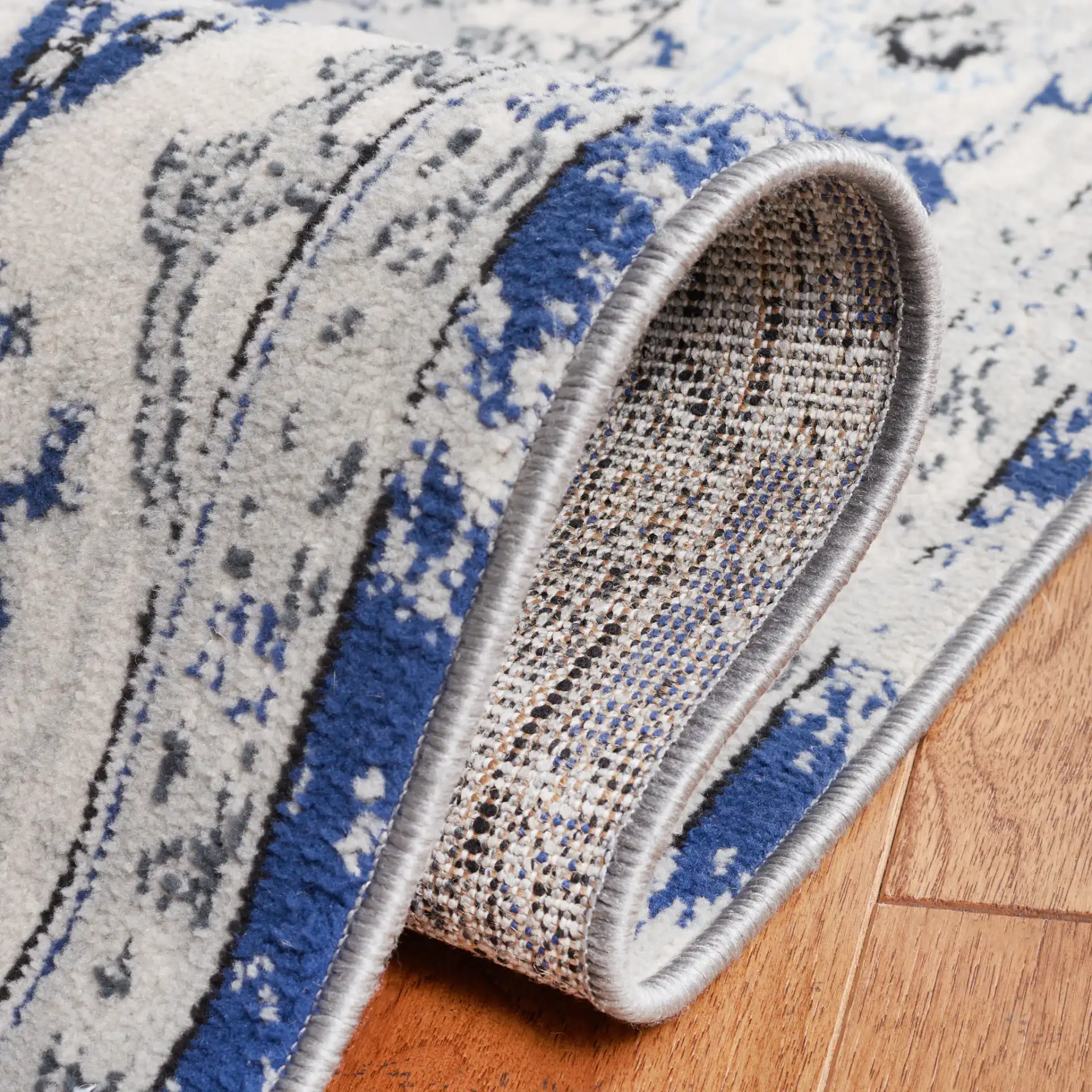 Odyssey Distressed Floral Border Rug in Gray / Navy in a styled room