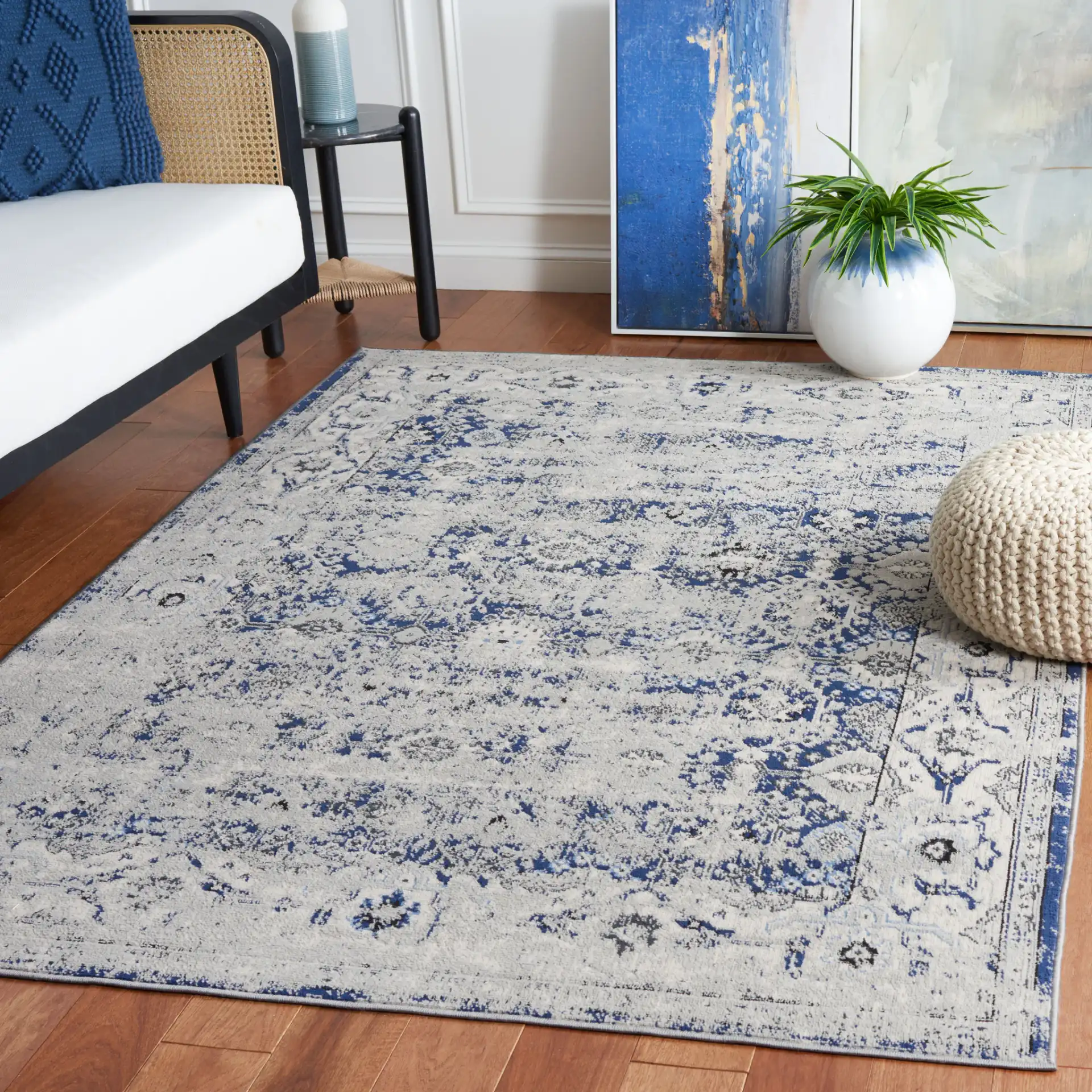 Odyssey Distressed Floral Border Rug in Gray / Navy in a styled room