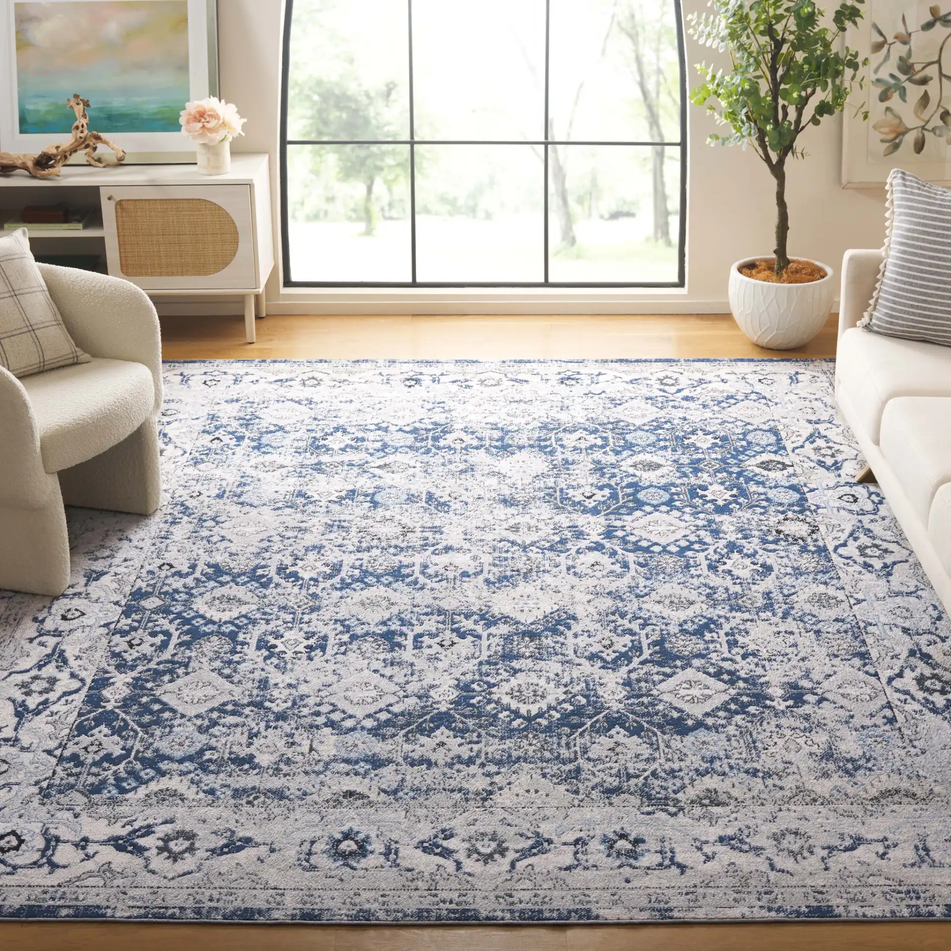 Odyssey Distressed Floral Border Rug in Gray / Navy in a styled room