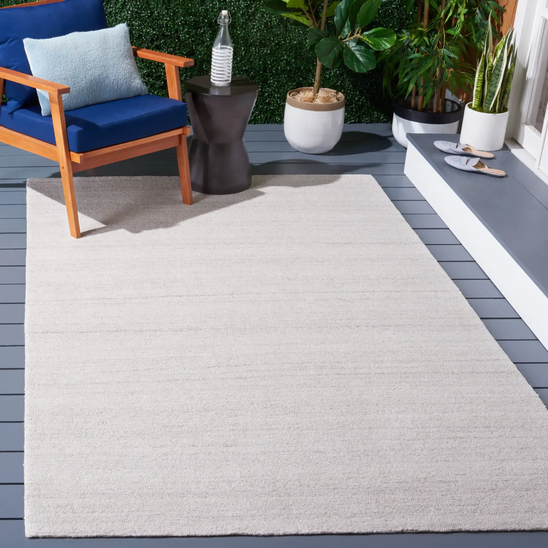 Outdoor Micro-Loop Solid Hand-Tufted Rug in Beige in a styled room