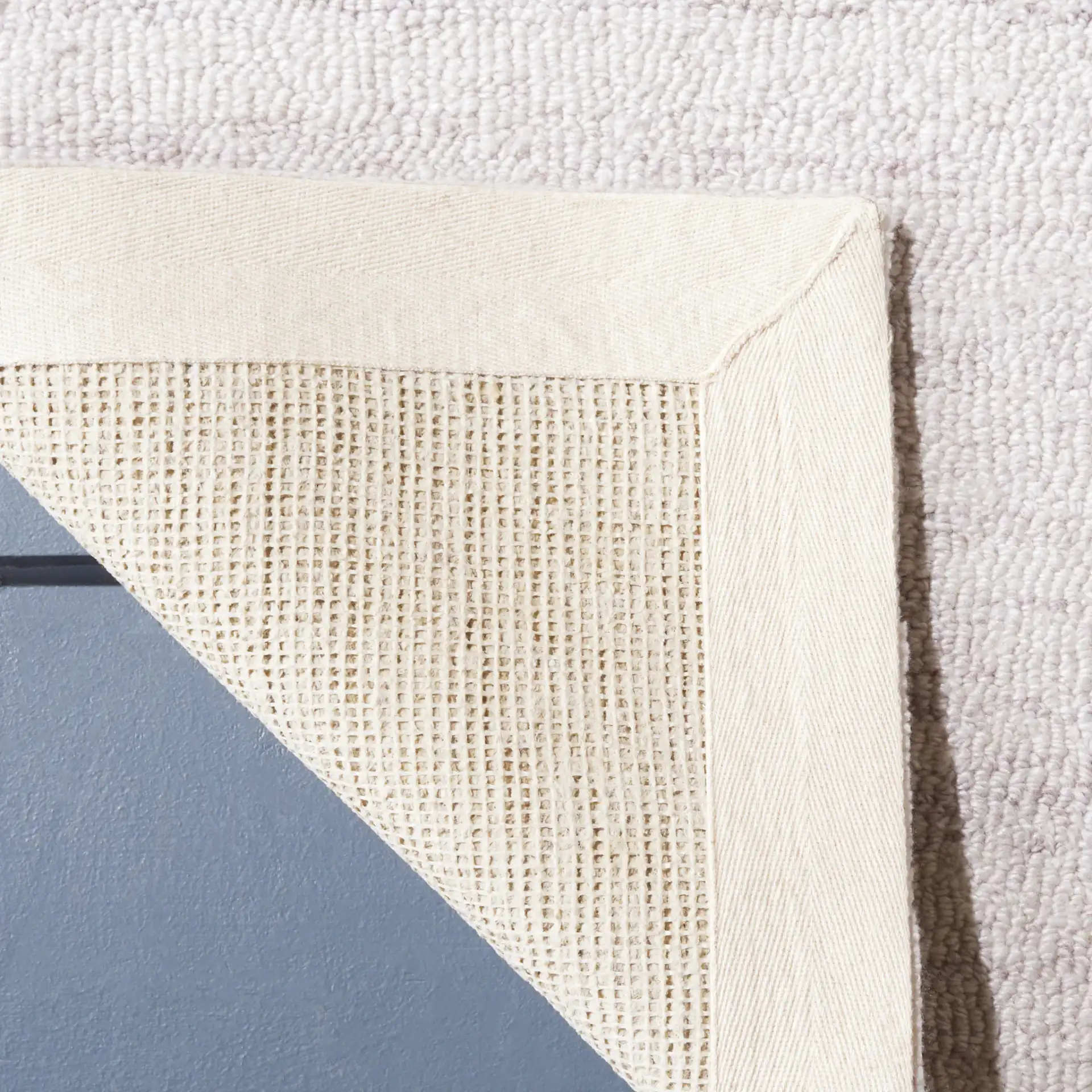 Outdoor Micro-Loop Solid Hand-Tufted Rug in Beige in a styled room