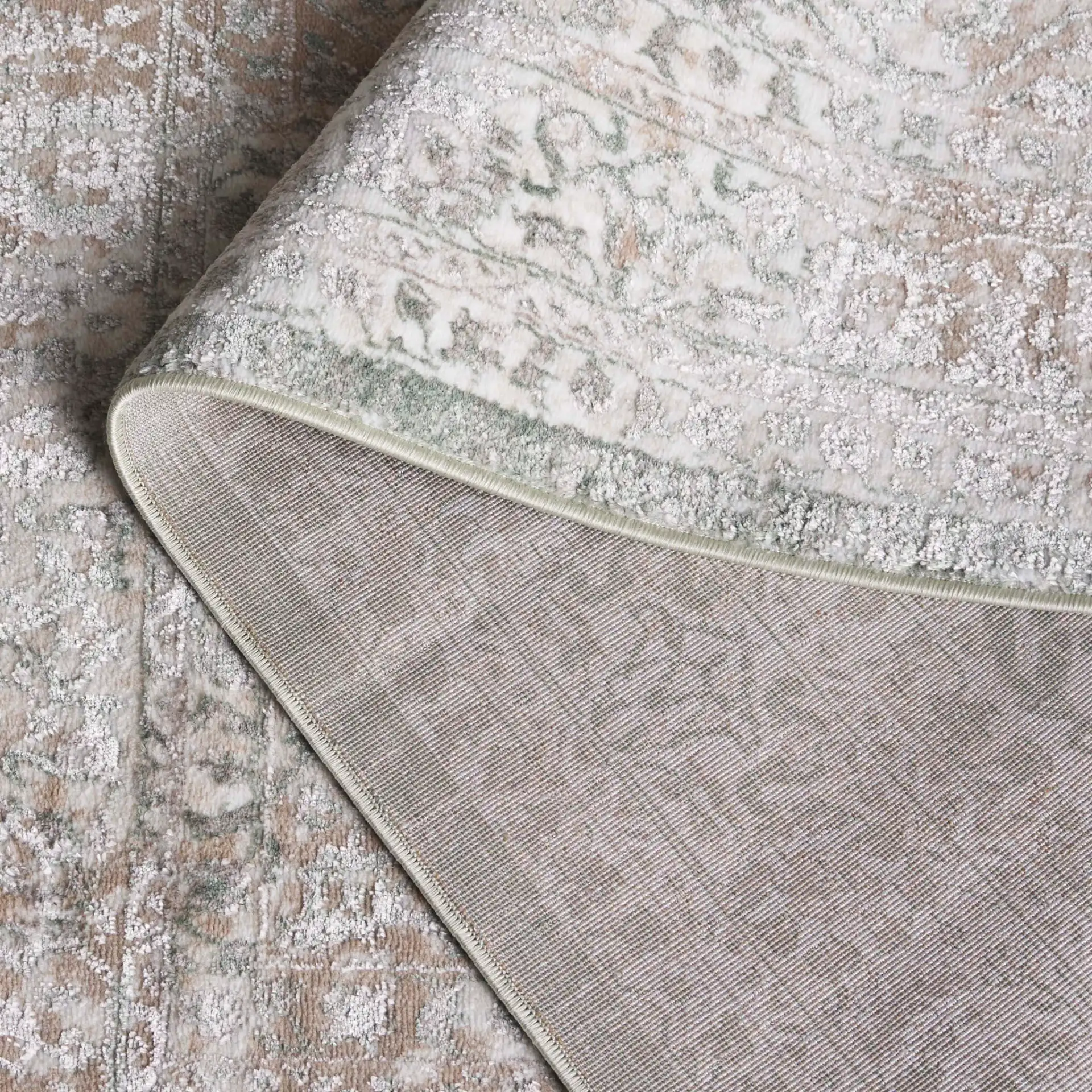 Orchard Medallion Bordered Rug in Green / Ivory in a styled room