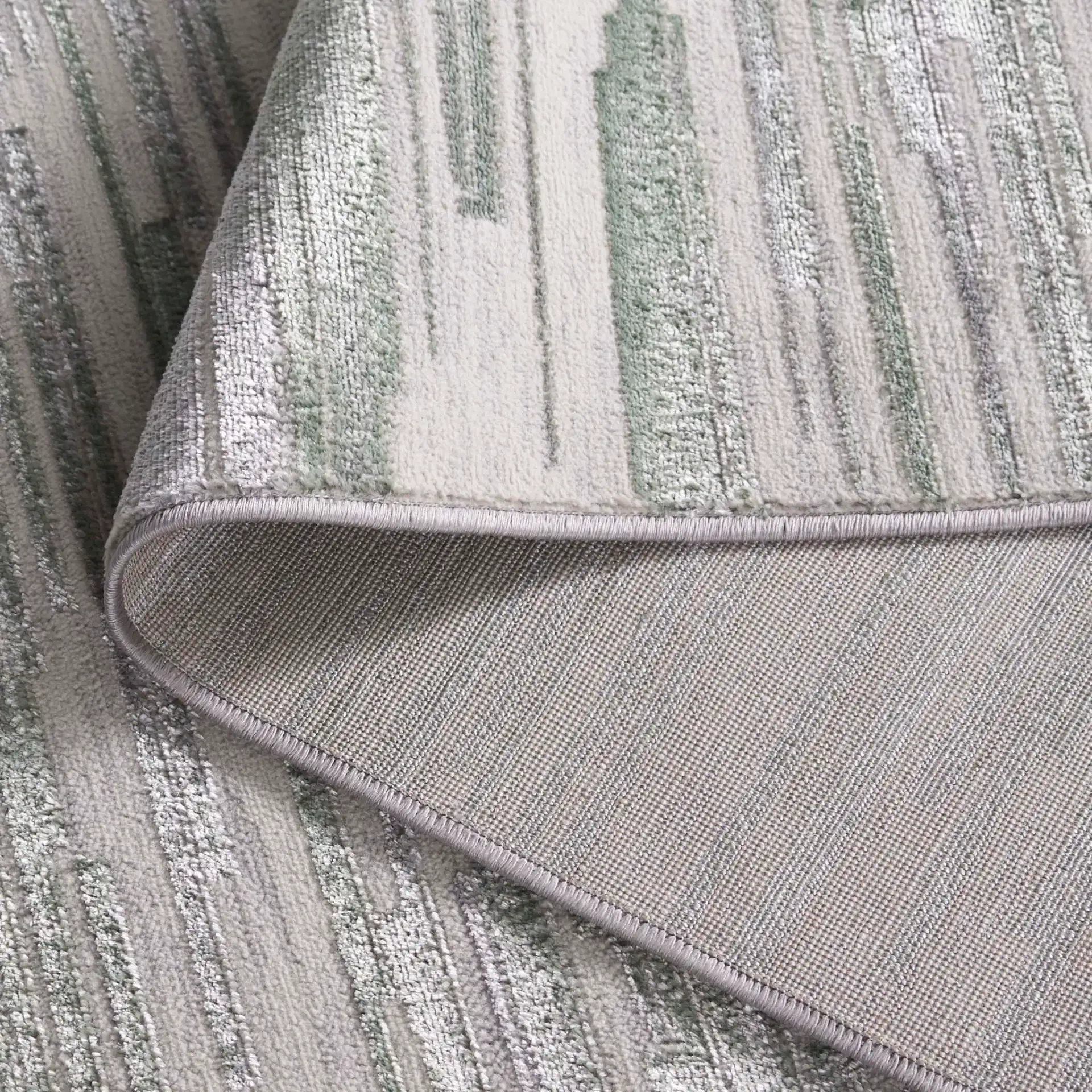 Orchard Abstract Stripe Rug in Gray / Green in a styled room
