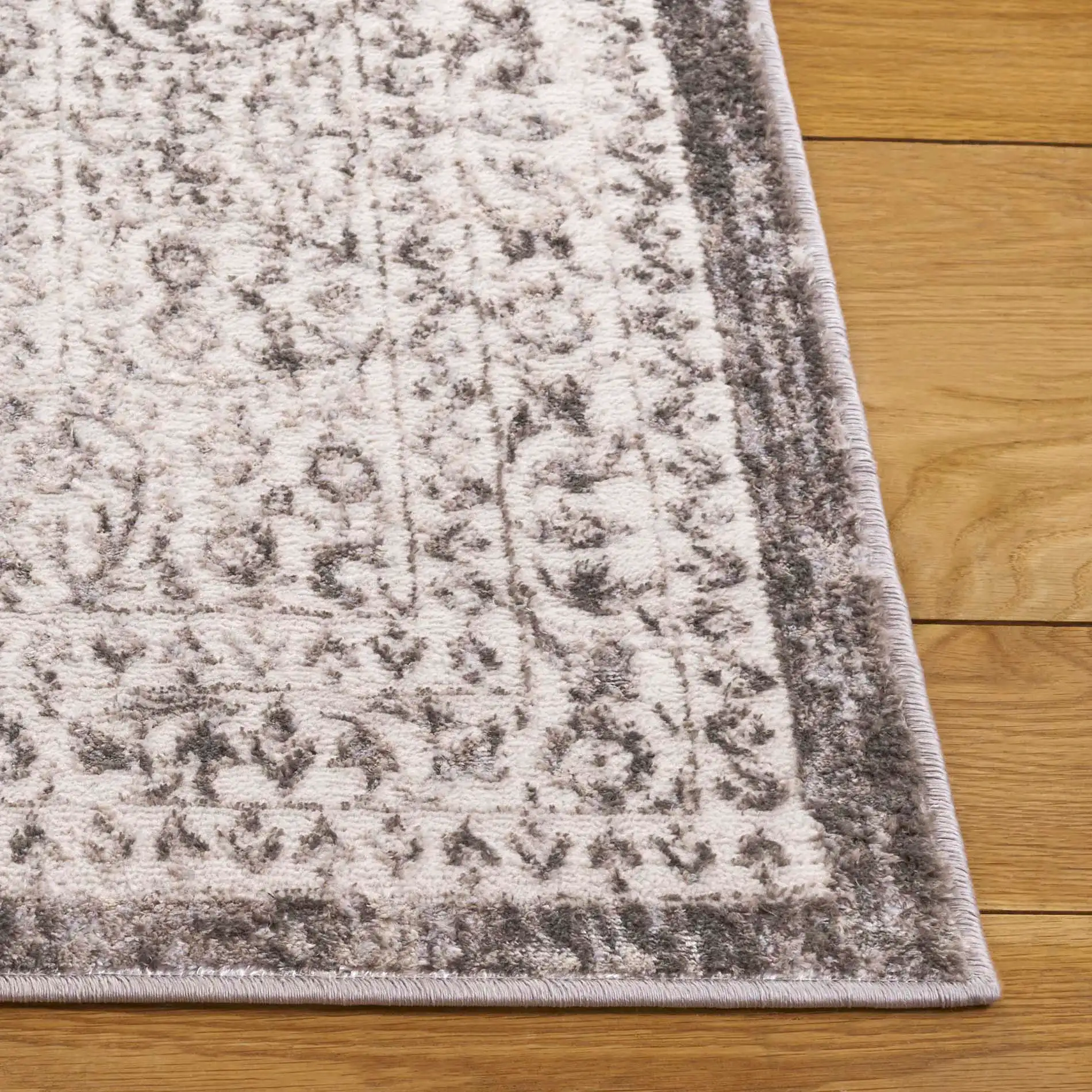 Orchard Vintage Floral Medallion Rug in Gray / Silver in a styled room