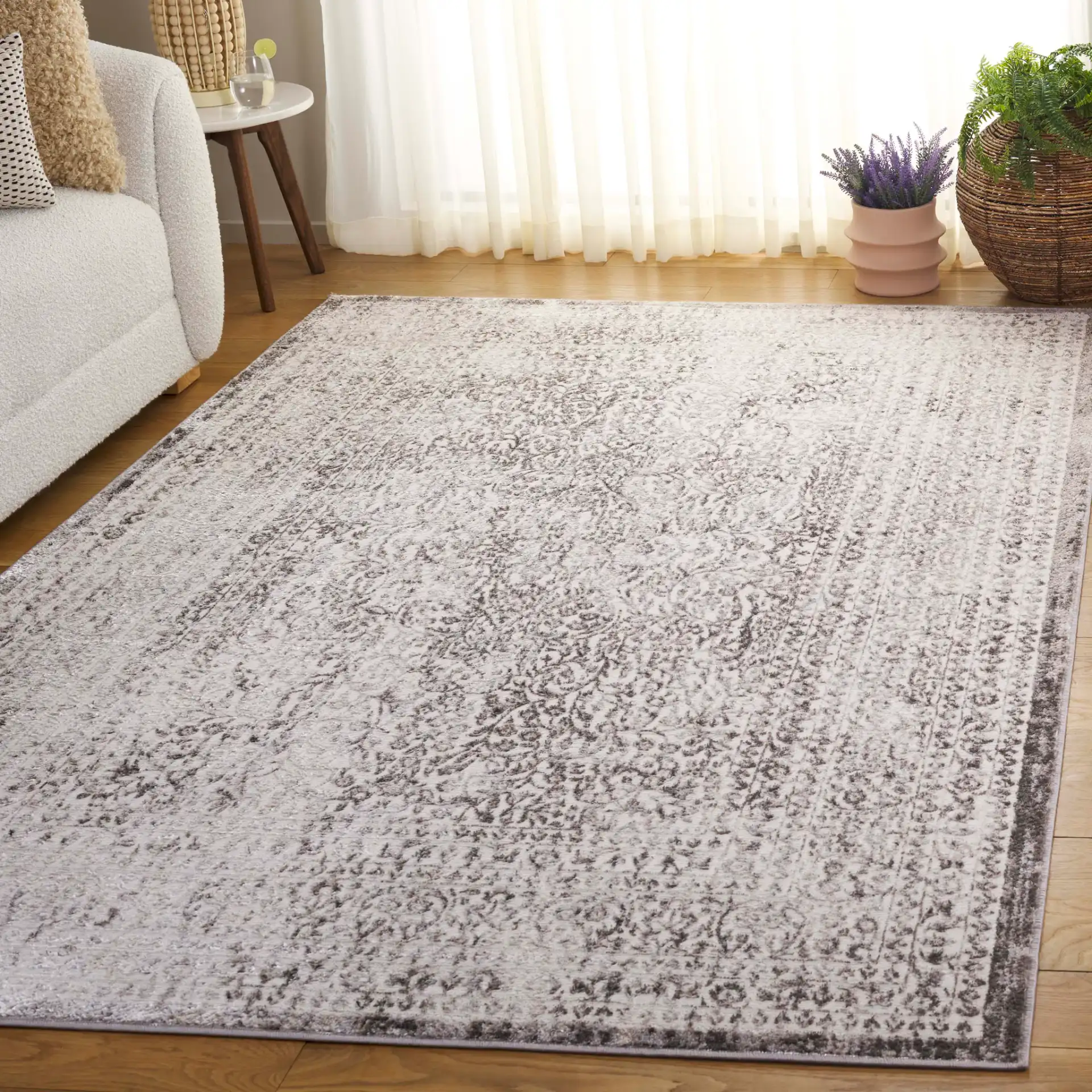 Orchard Vintage Floral Medallion Rug in Gray / Silver in a styled room
