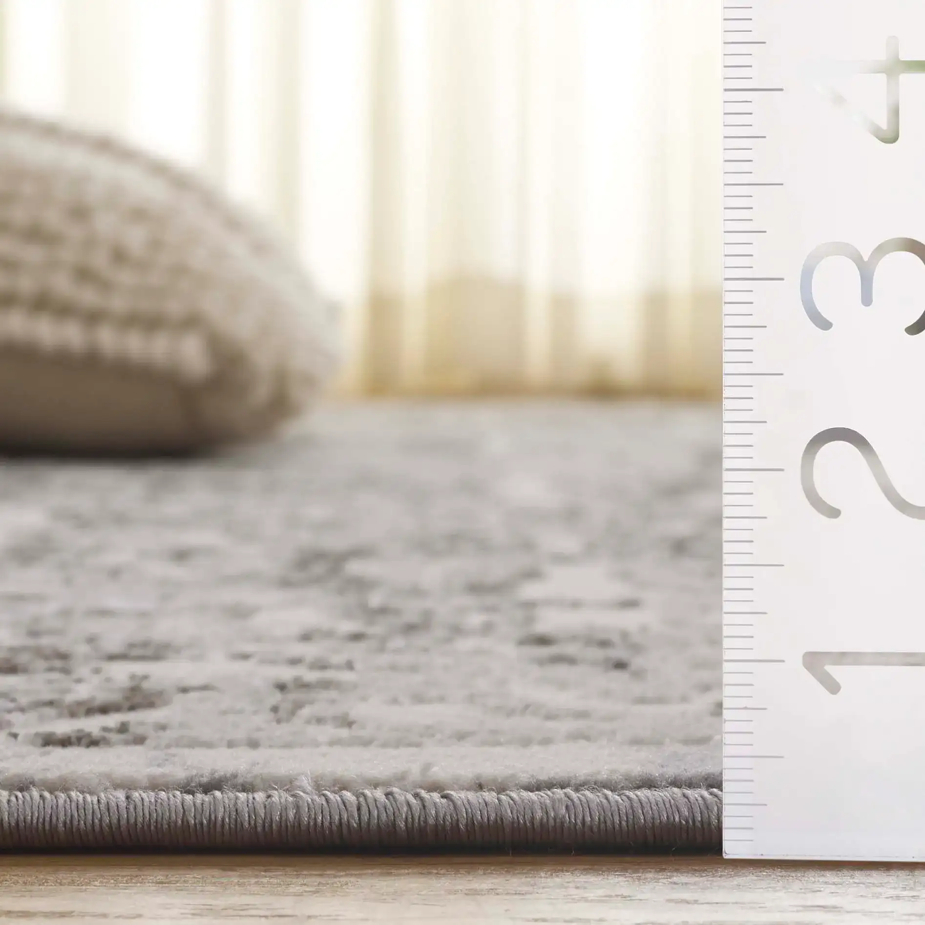Orchard Distressed Damask Rug in Gray / Silver in a styled room